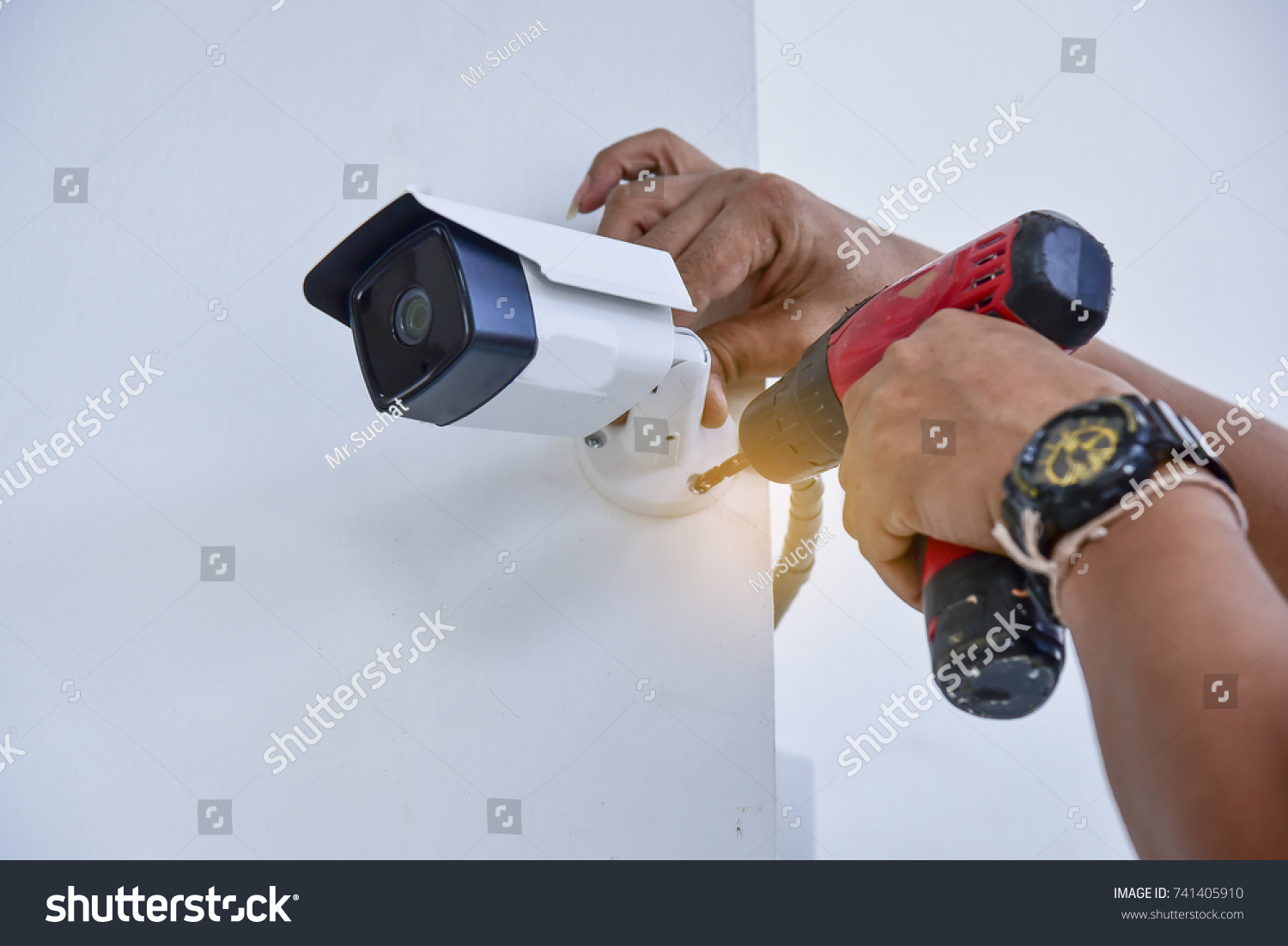 Technician installing CCTV camera for security #741405910