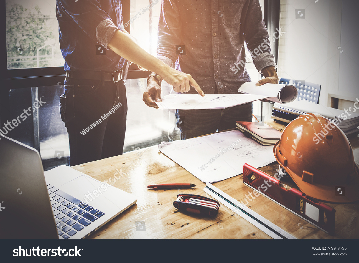 Two Architect man working with compasses and blueprints for architectural plan,engineer sketching a construction project concept. #749919796