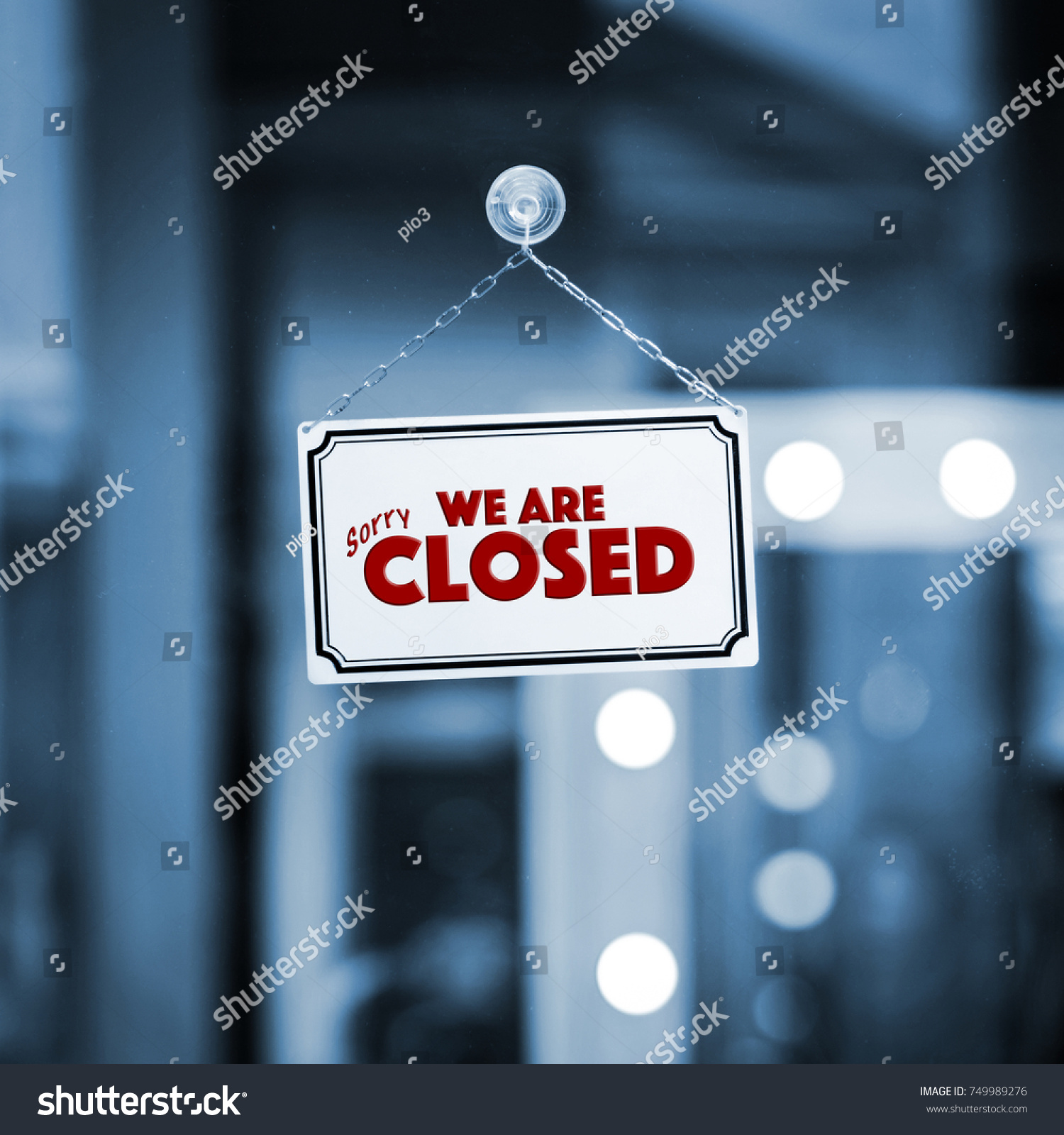 WE ARE CLOSED sign board through the glass of store window. Filtered image. #749989276