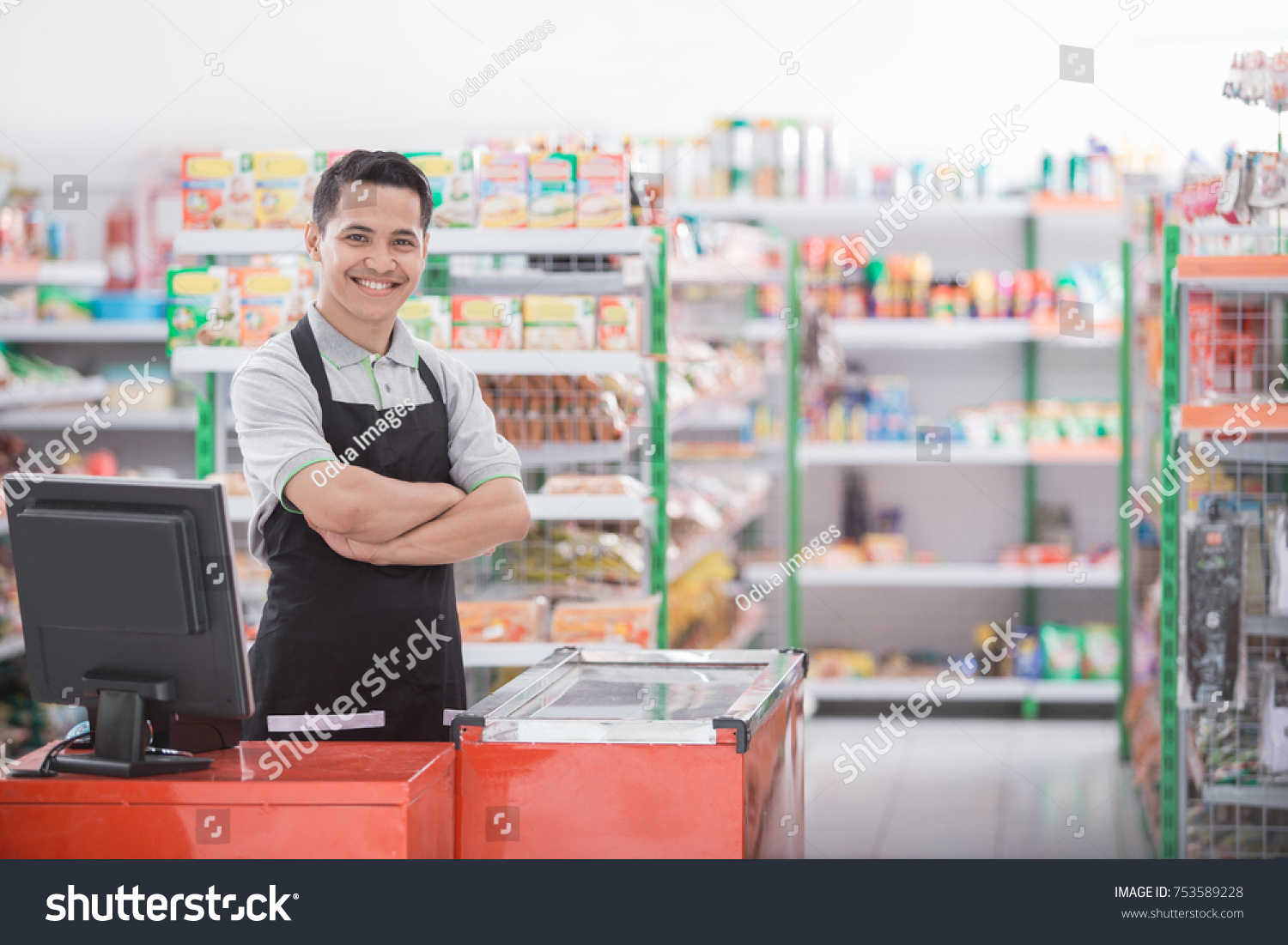 Portrait of a smiling shopkeeper in a grocery store #753589228