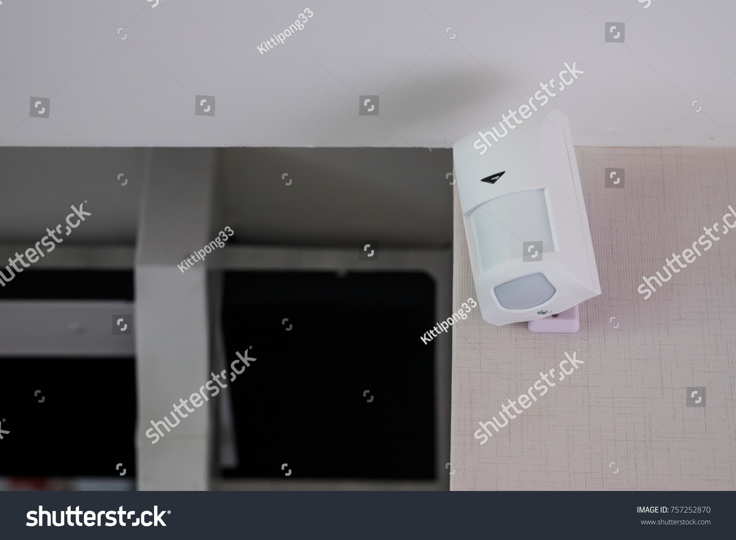 Motion detector attached on blue wall #757252870