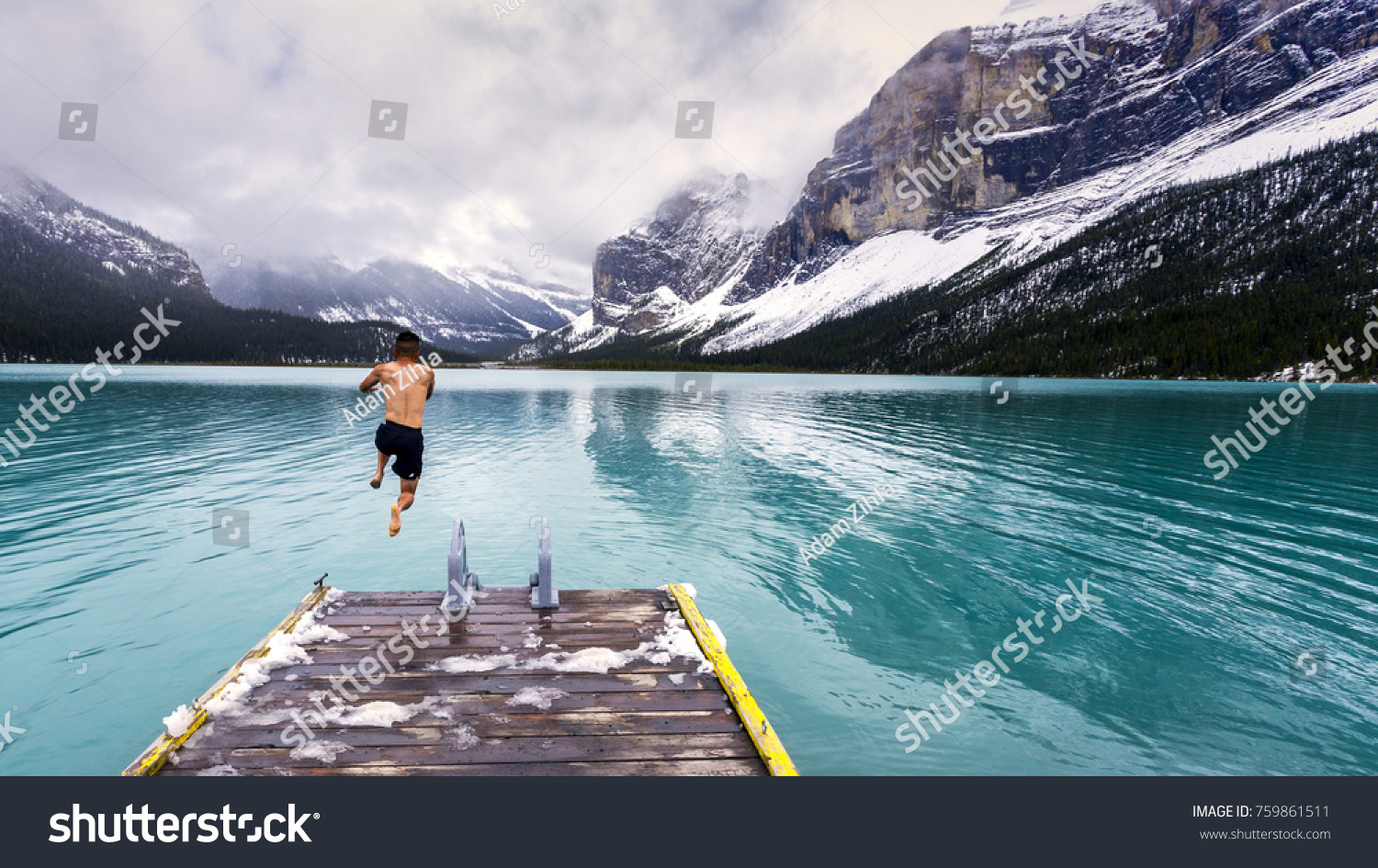 Bold jump into the cold waters of Maligne Lake in Jasper National Park #759861511