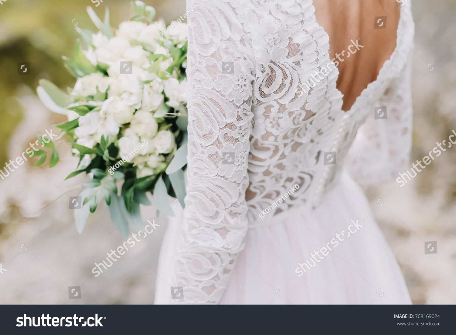 Bride holds a wedding bouquet, wedding dress, wedding details #768169024