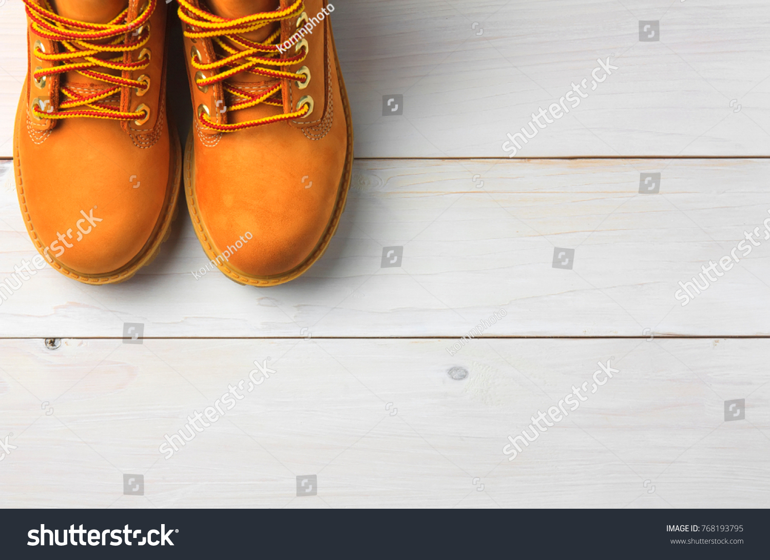 brown or yellow boots shoes for foot and adventure travel place on vintage white floor or table with copy space #768193795