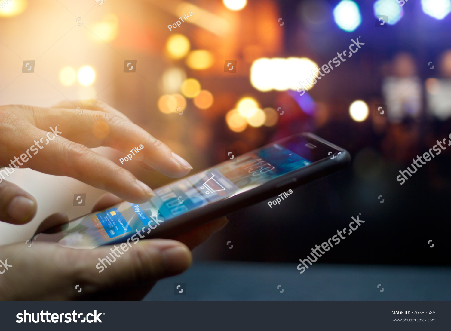 Mobile payment, Man using mobile payments online shopping and icon on night background, All on screen and credit card are design up. #776386588