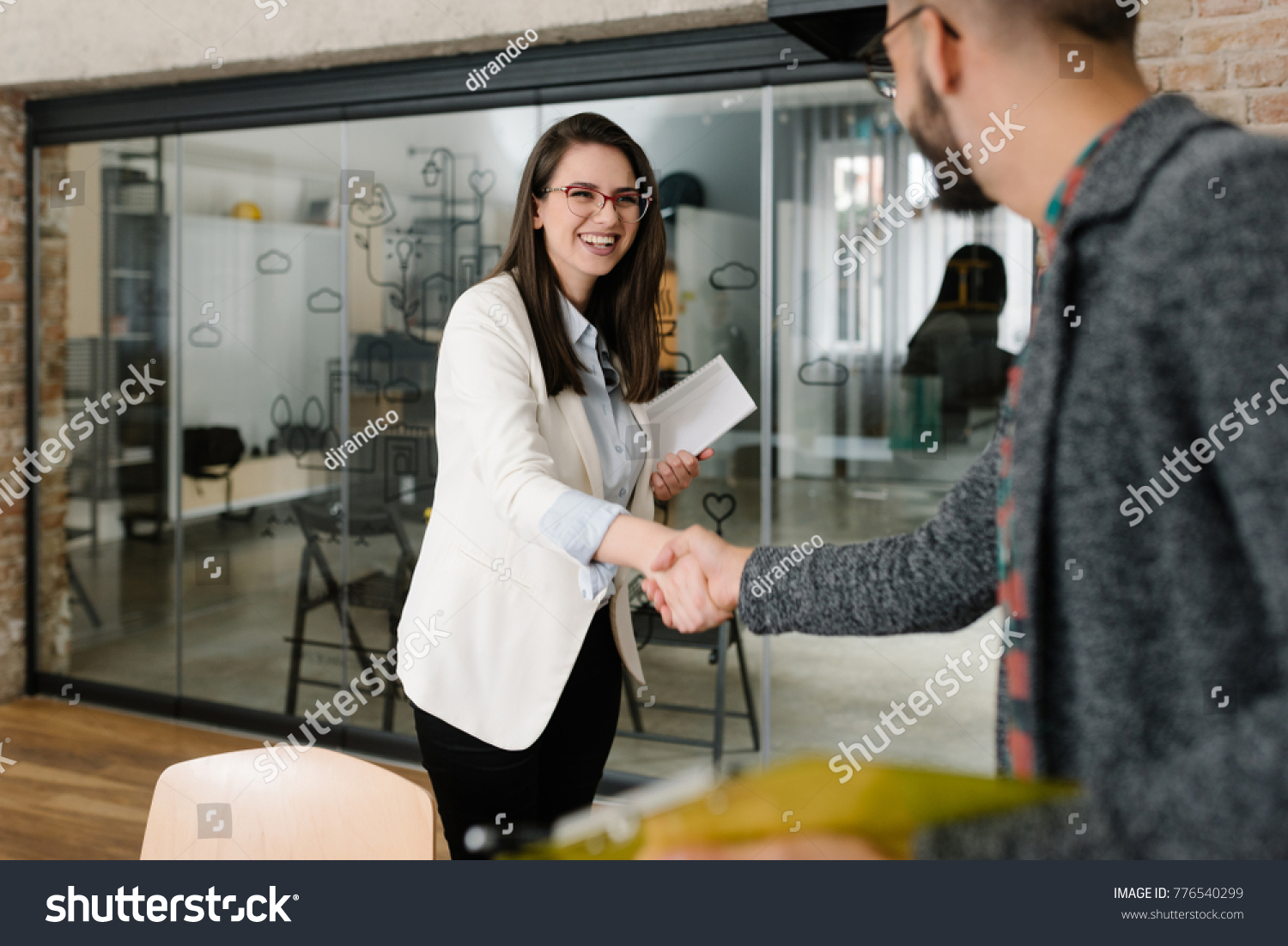 Openly greeting a job recruiter with a firm handshake #776540299