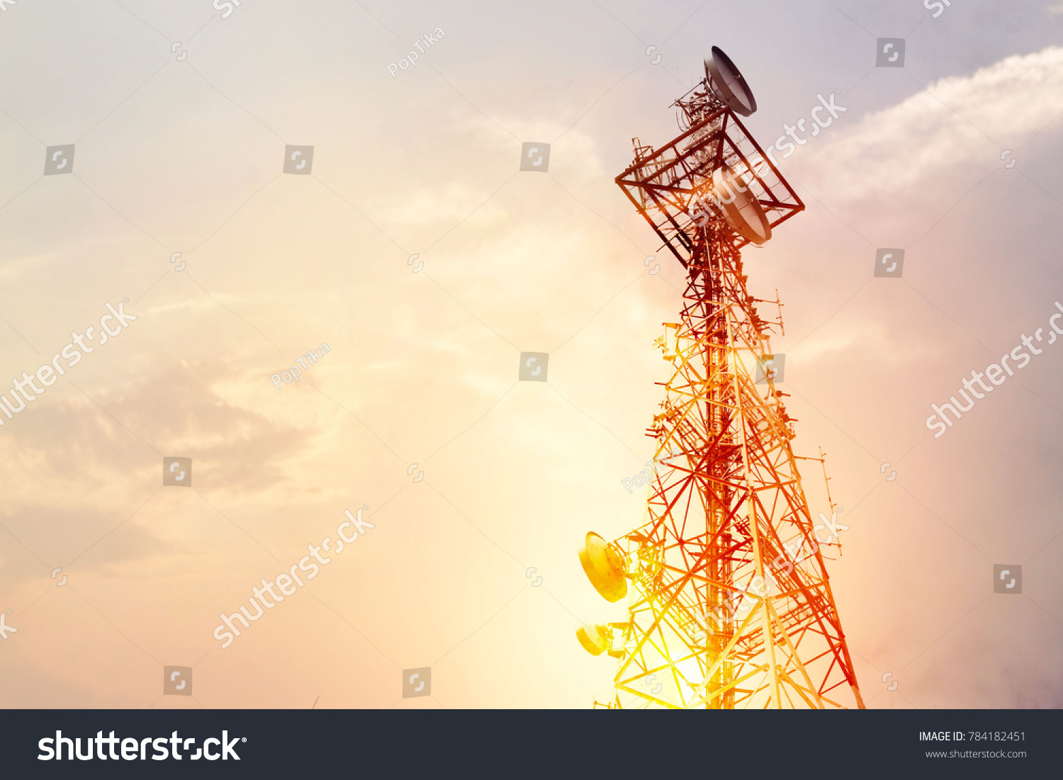 Abstract telecommunication tower Antenna and satellite dish at sunset sky background #784182451