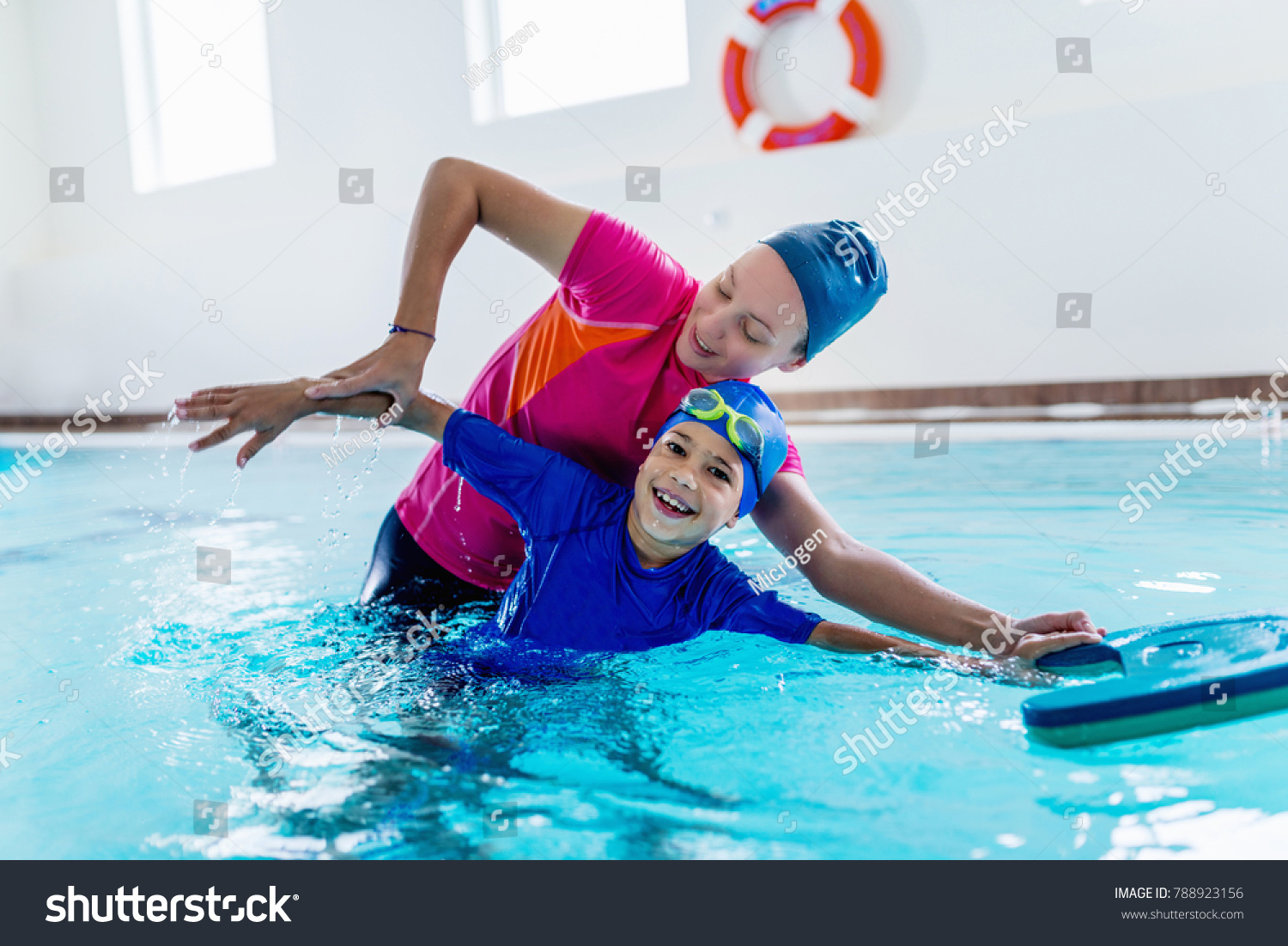 Boy having a swimming lesson with instructor #788923156
