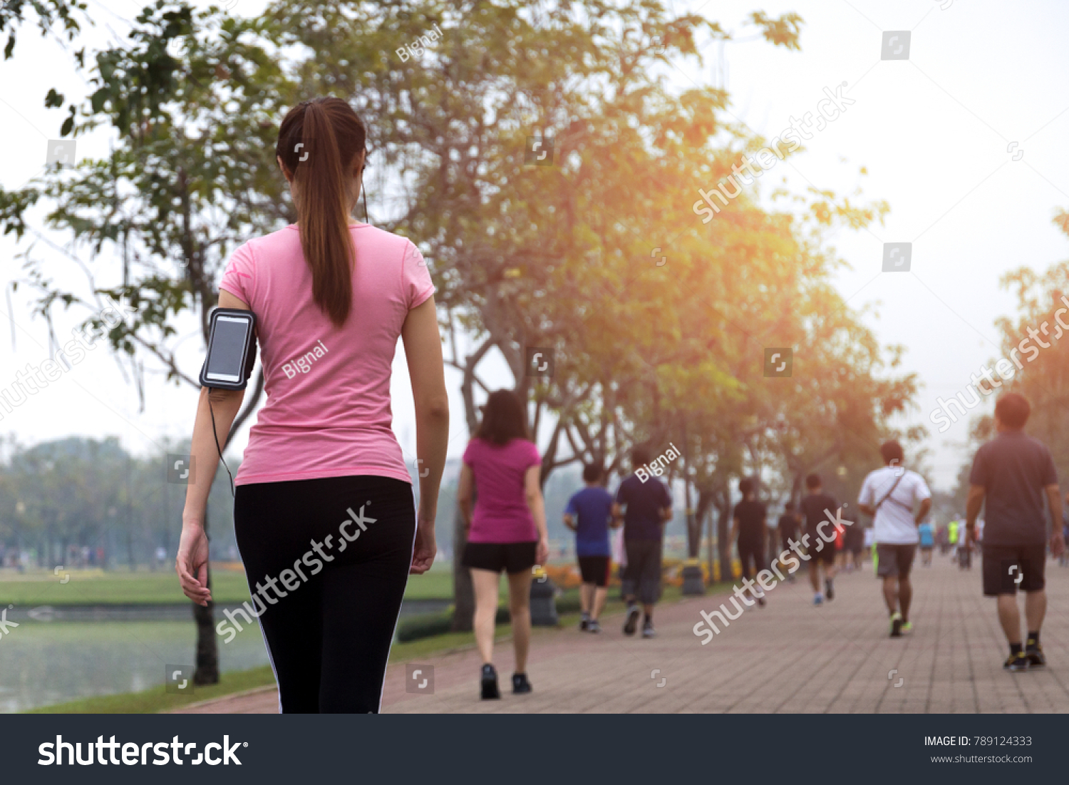 Group of people exercise walking in the park in morning #789124333