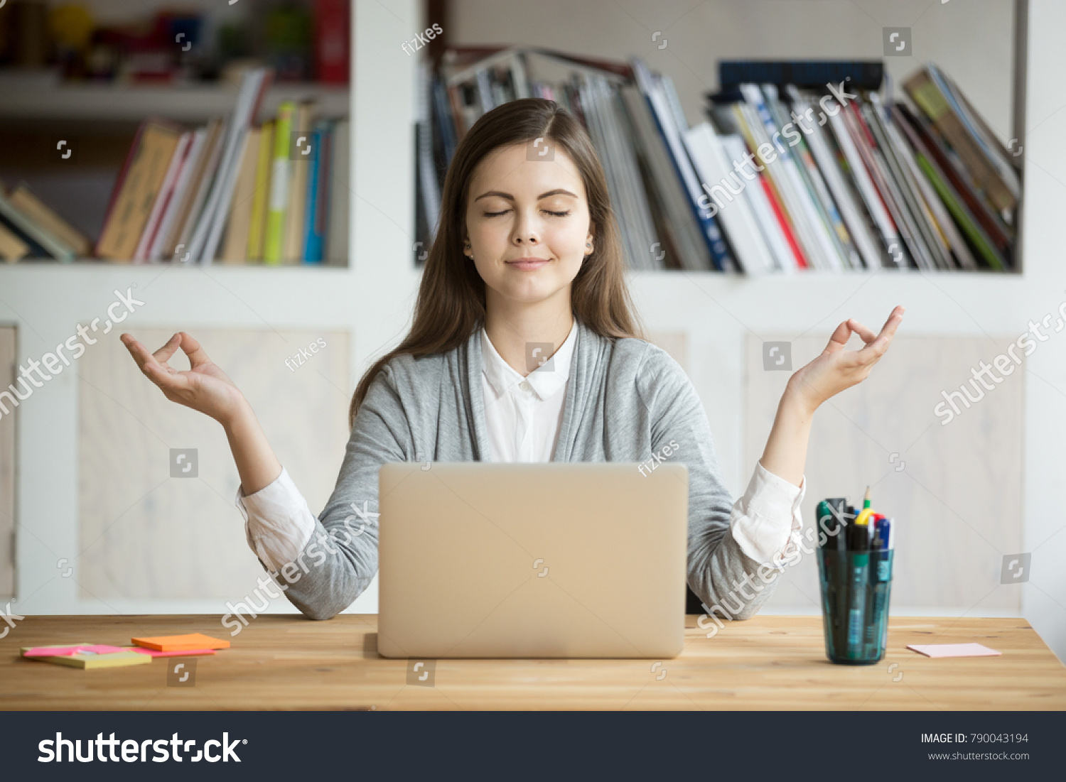 Calm woman relaxing meditating with laptop, no stress free relief at work concept, mindful peaceful young businesswoman or student practicing breathing yoga exercises at workplace, office meditation #790043194