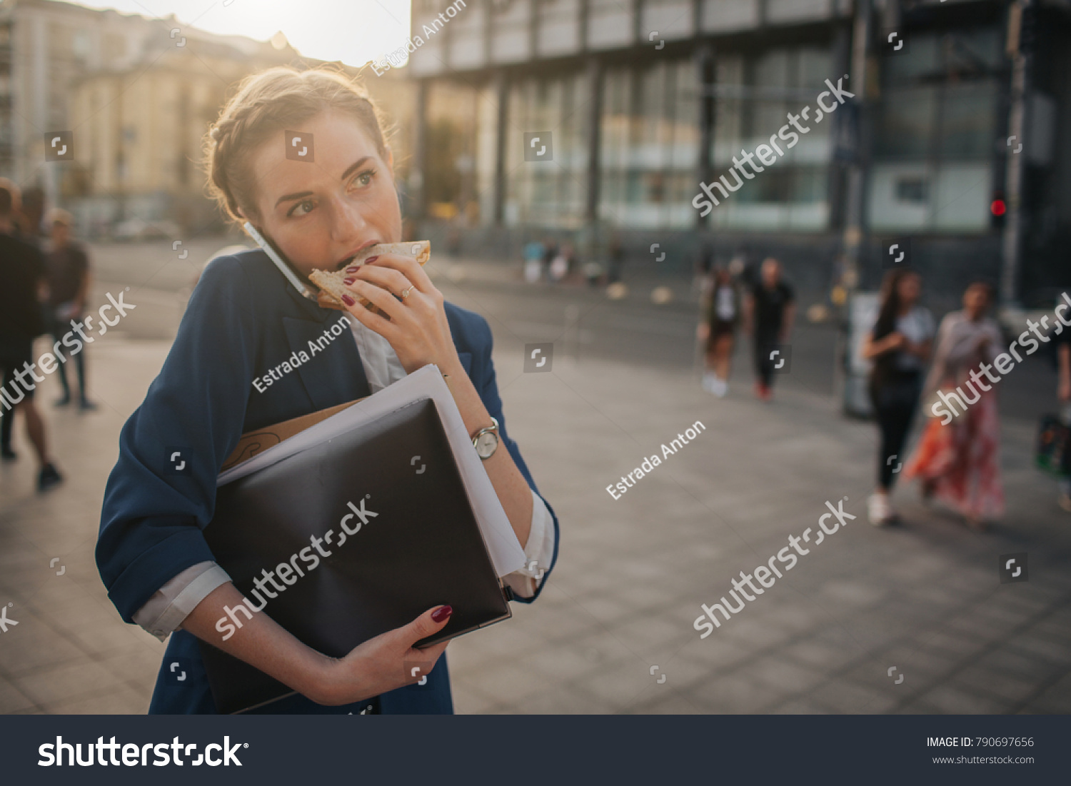 Busy woman is in a hurry, she does not have time, she is going to eat snack on the go. Worker eating, drinking coffee, talking on the phone, at the same time. Businesswoman doing multiple tasks #790697656