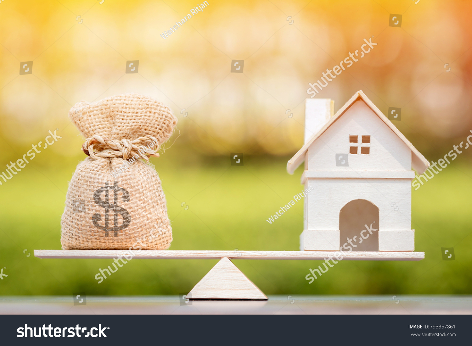 Home and money bag put on the scales with balance put on the wood in the public park, Saving for buy a new house or real estate and loan for plan business investment in the future concept. #793357861