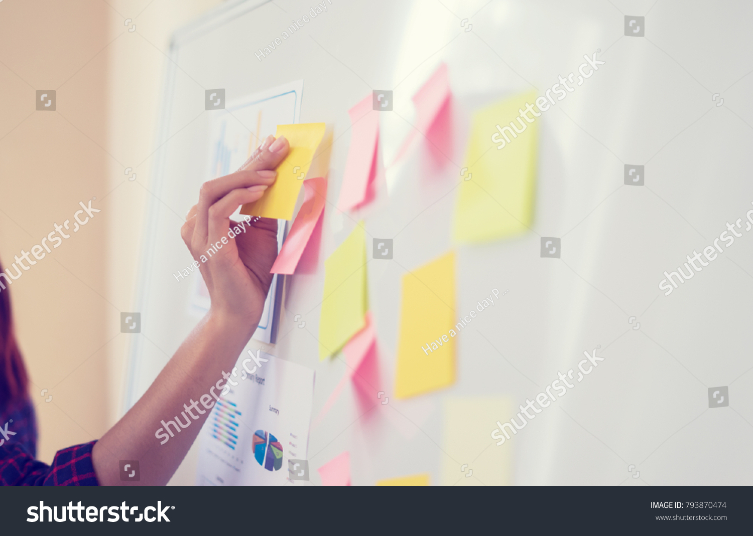 Business people meeting at office and use post it notes to share idea. Brainstorming concept. Sticky note on glass wall.business women working and communicating together in creative office #793870474