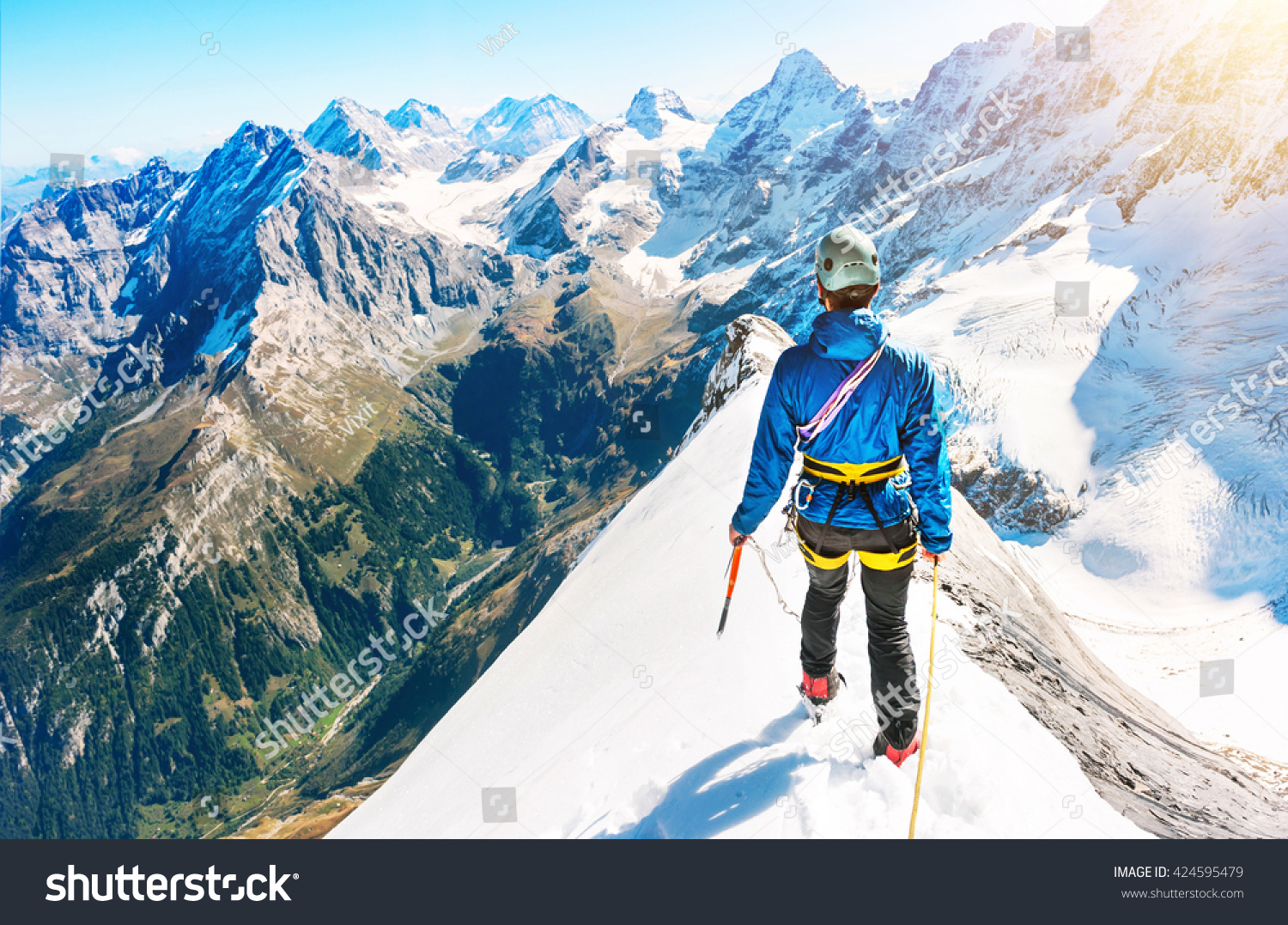 A Climber Reaching The Summit Of The Mountain Stock Photo 424595479 ...