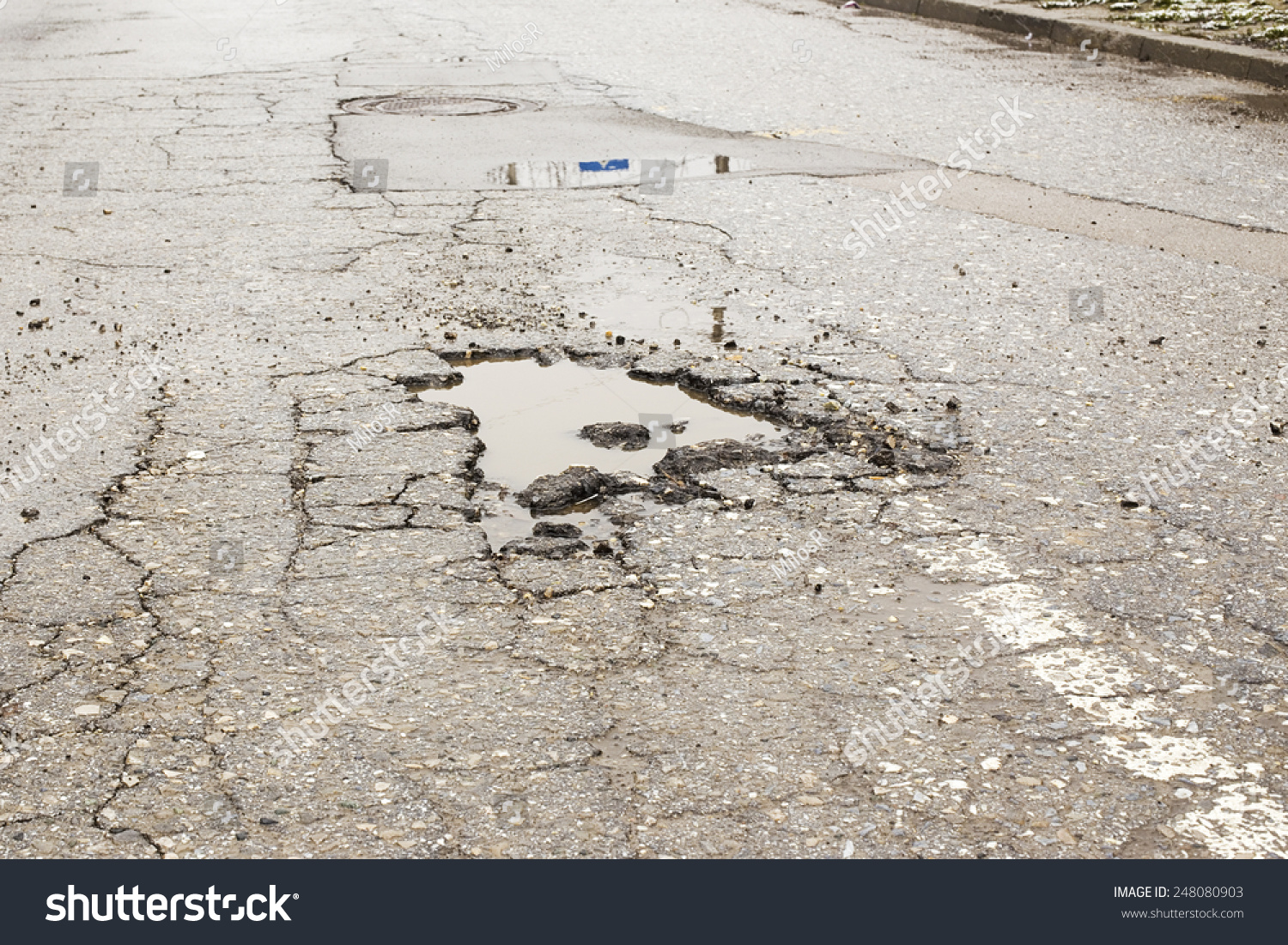 A Road Damaged By Rain And Snow, That Is In Need Of Maintenance. Broken ...