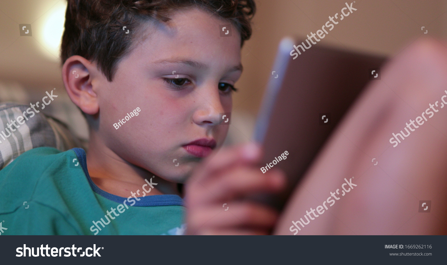 Candid Child Home Staring Screen Holding Stock Photo (Edit Now) 1669262116