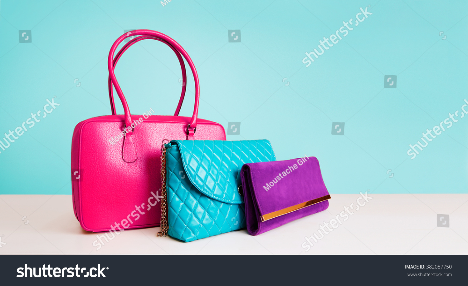 3 Colorful Fashion Bags Purses Isolated On Light Blue Background. Stock ...