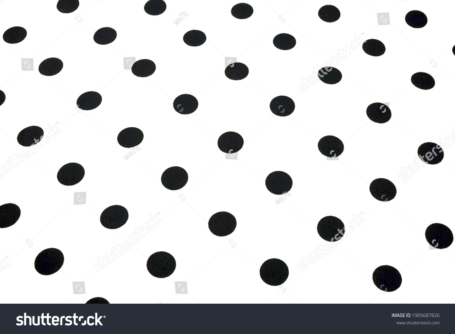  White wallpaper with black polka dots-close-up. 