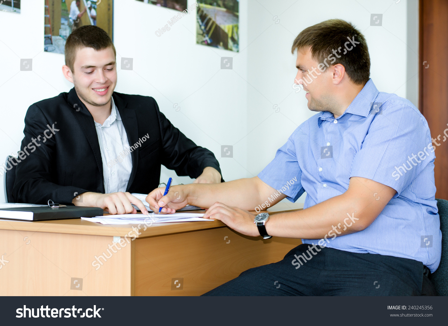 推销员或房地产经纪人签订协议与男性客户微笑