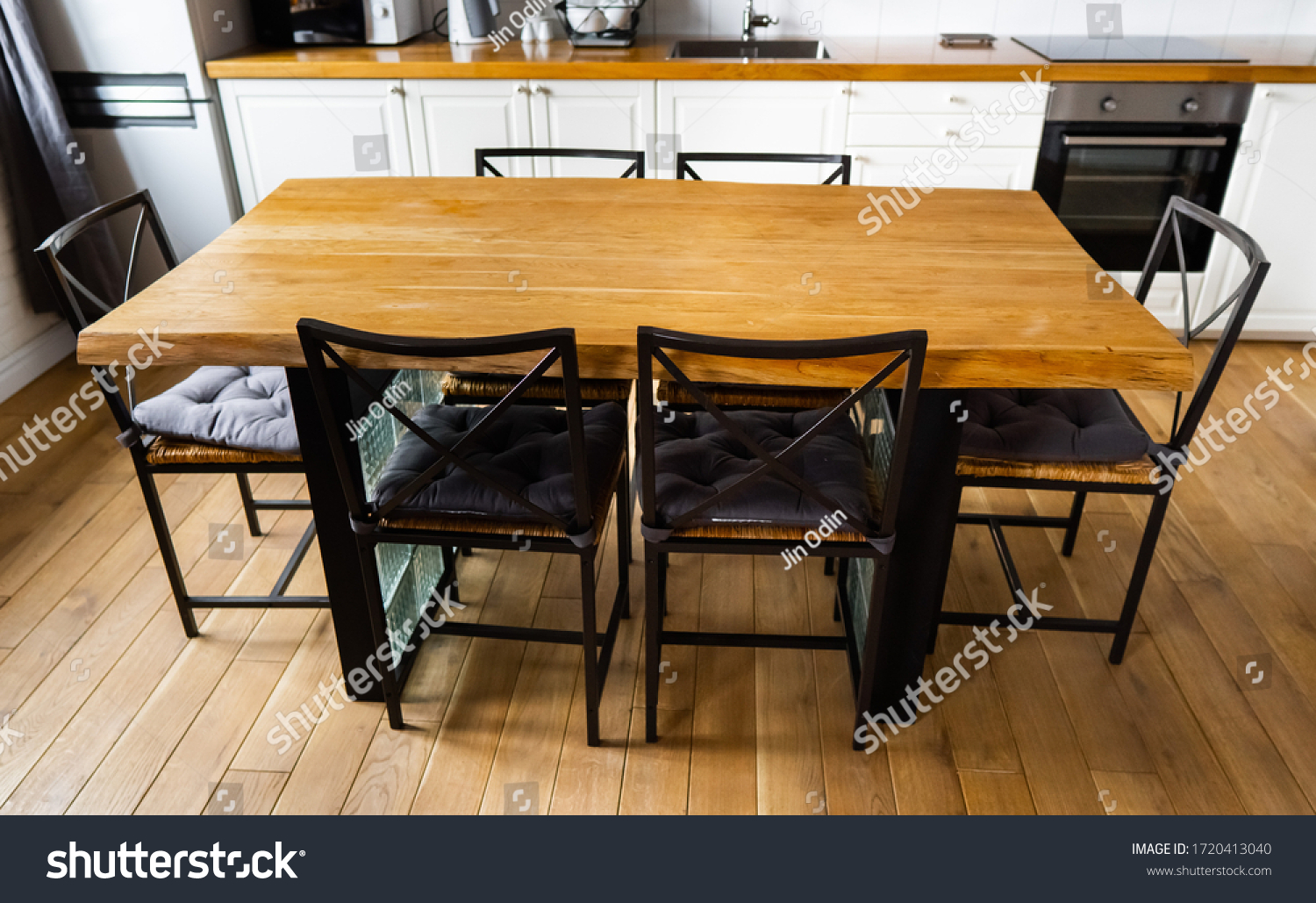 Stock Photo A Big Wooden Dining Table With Glass Blocks And Metal Wicker Chairs And Pillows In Modern 1720413040 