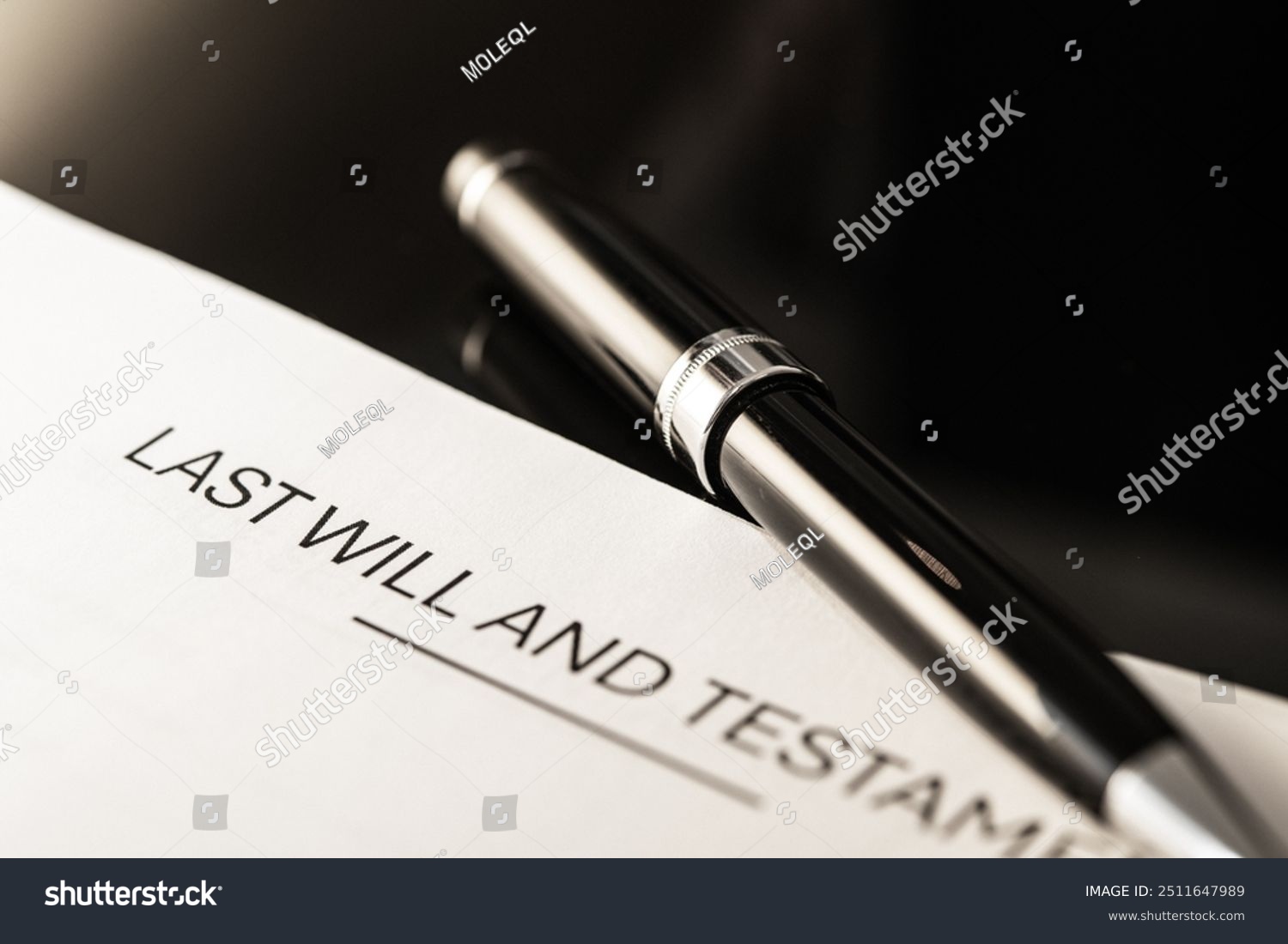 A pen is sitting on top of a last will and testament.