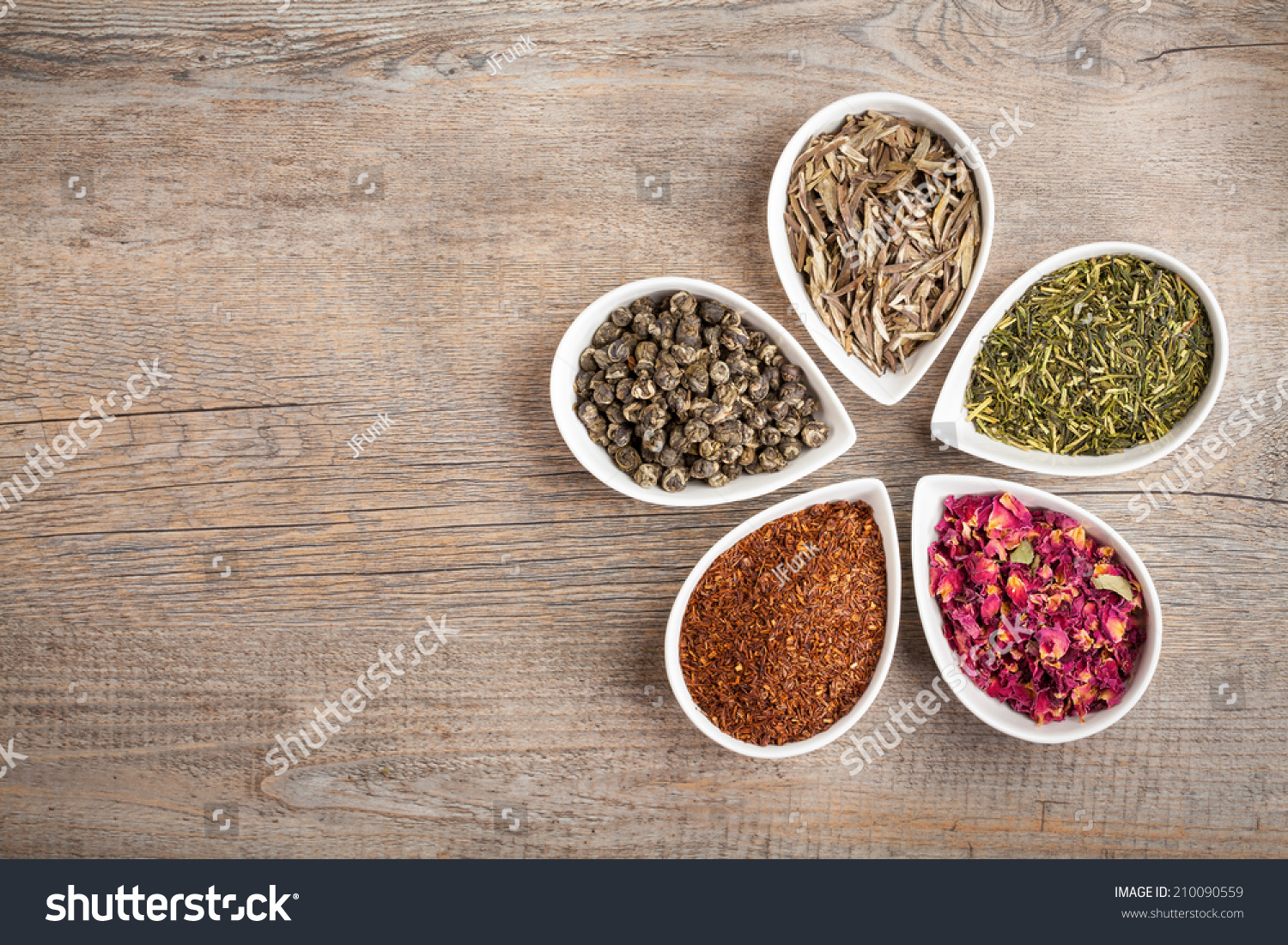 A Colorful Assortment Of Loose Teas In Petal Shaped Bowls On A Wooden ...