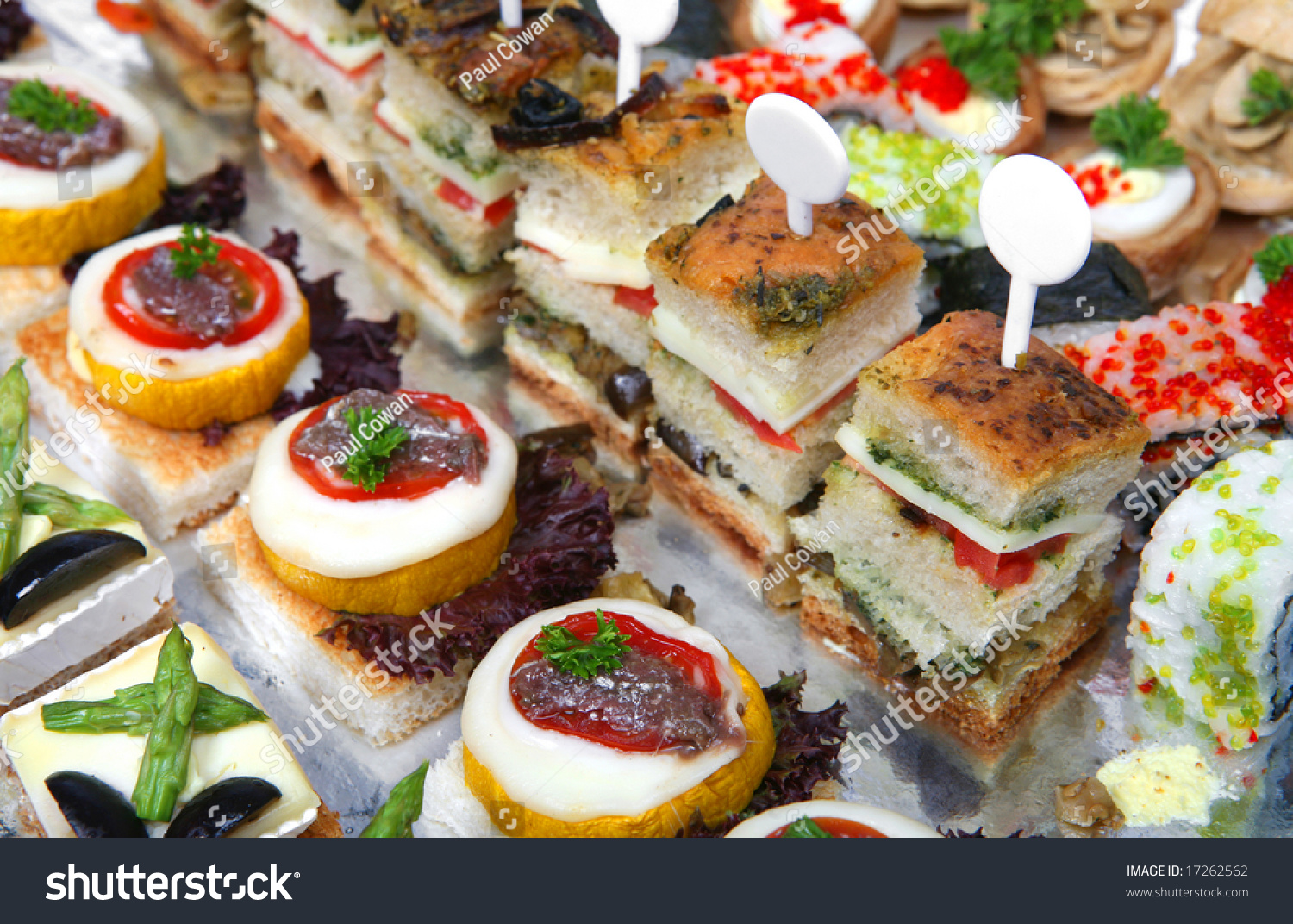 A Foil Covered Tray Of Assorted Gourmet Canapes, Including Sushi, Quail ...