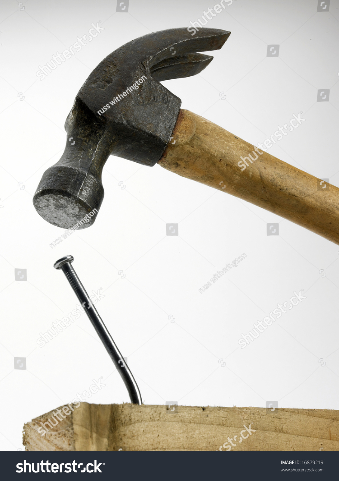 A Hammer In Close Proximity To Bent Nail In Piece Of Timber Stock Photo ...