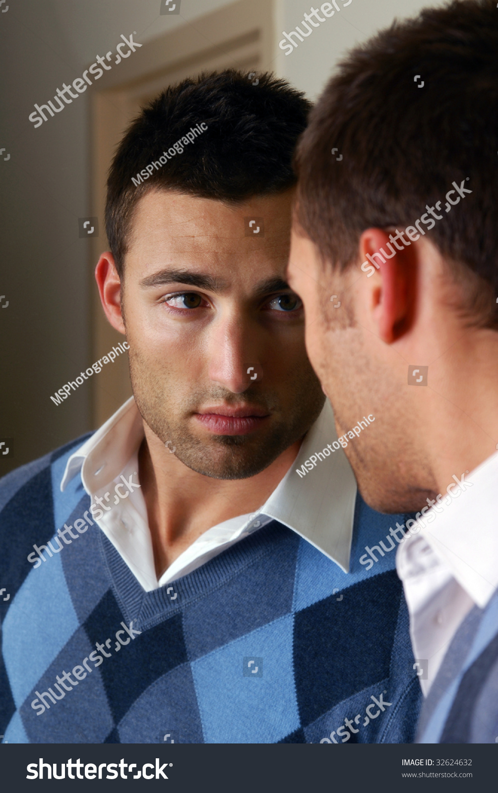 A Handsome Man Looking At Himself In The Mirror Stock Photo 32624632 ...