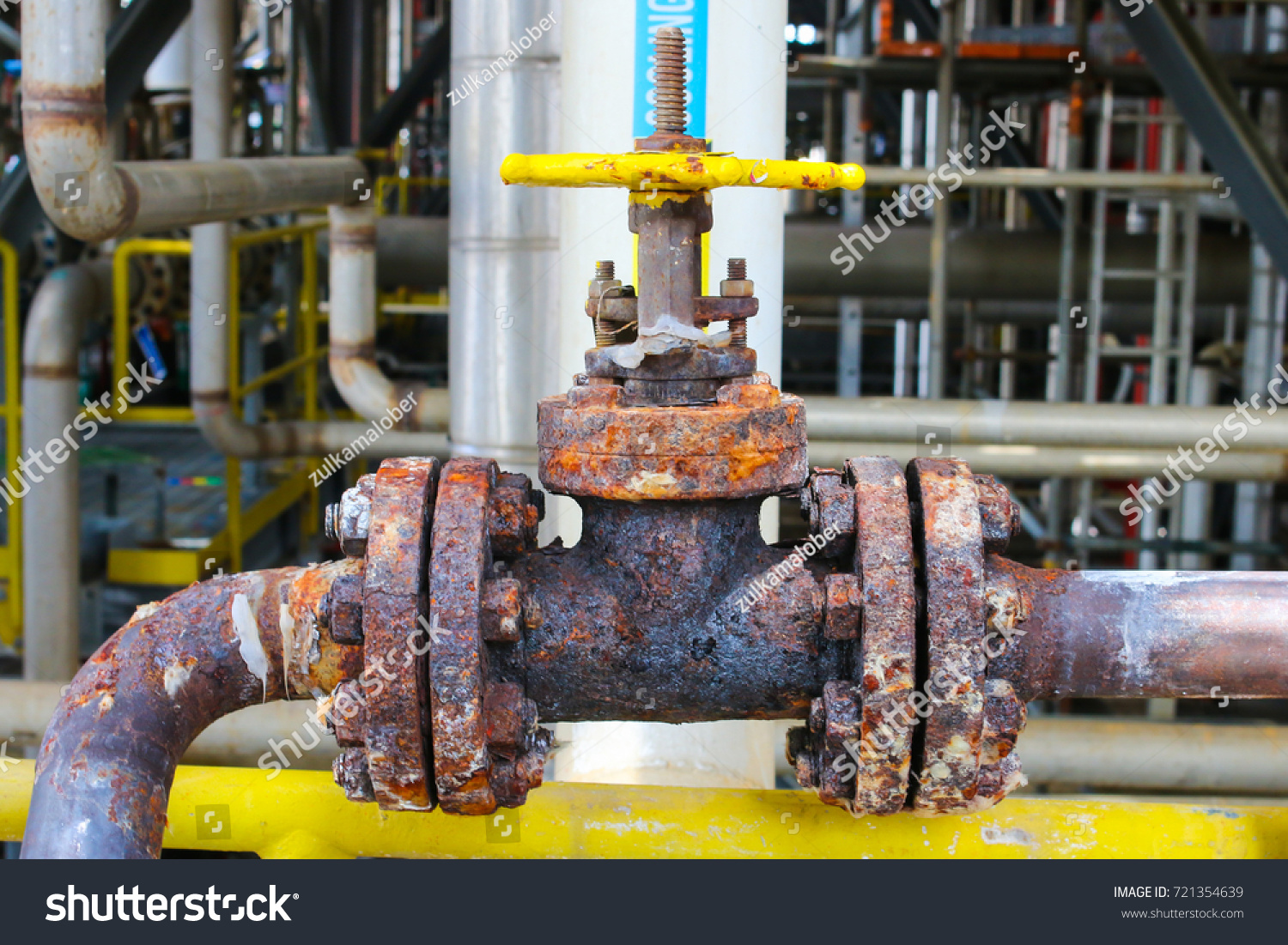 A heavily corroded manual valve in oil and gas refinery petrochemical plant.