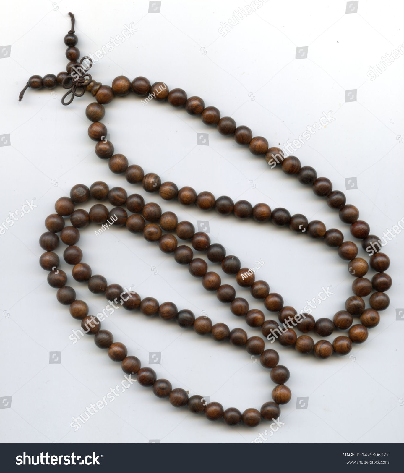 Woman's hand holding string of Japa Mala beads, close-up Stock