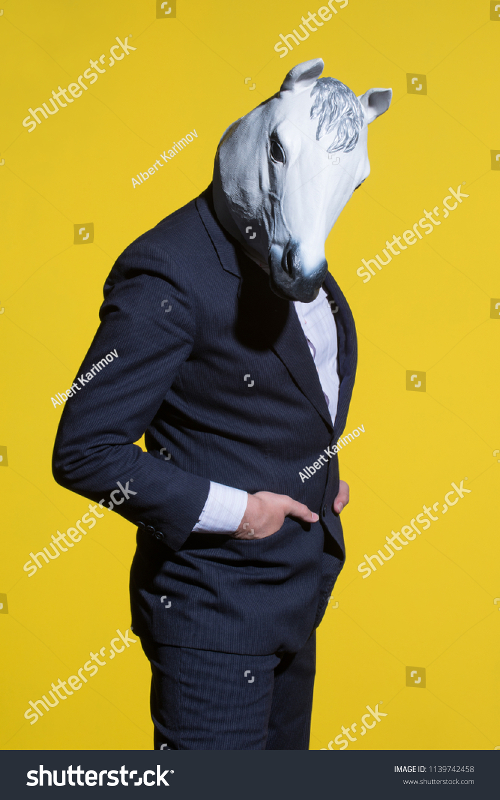 Download Man Suit Horse Mask On Yellow People Stock Image 1139742458 PSD Mockup Templates