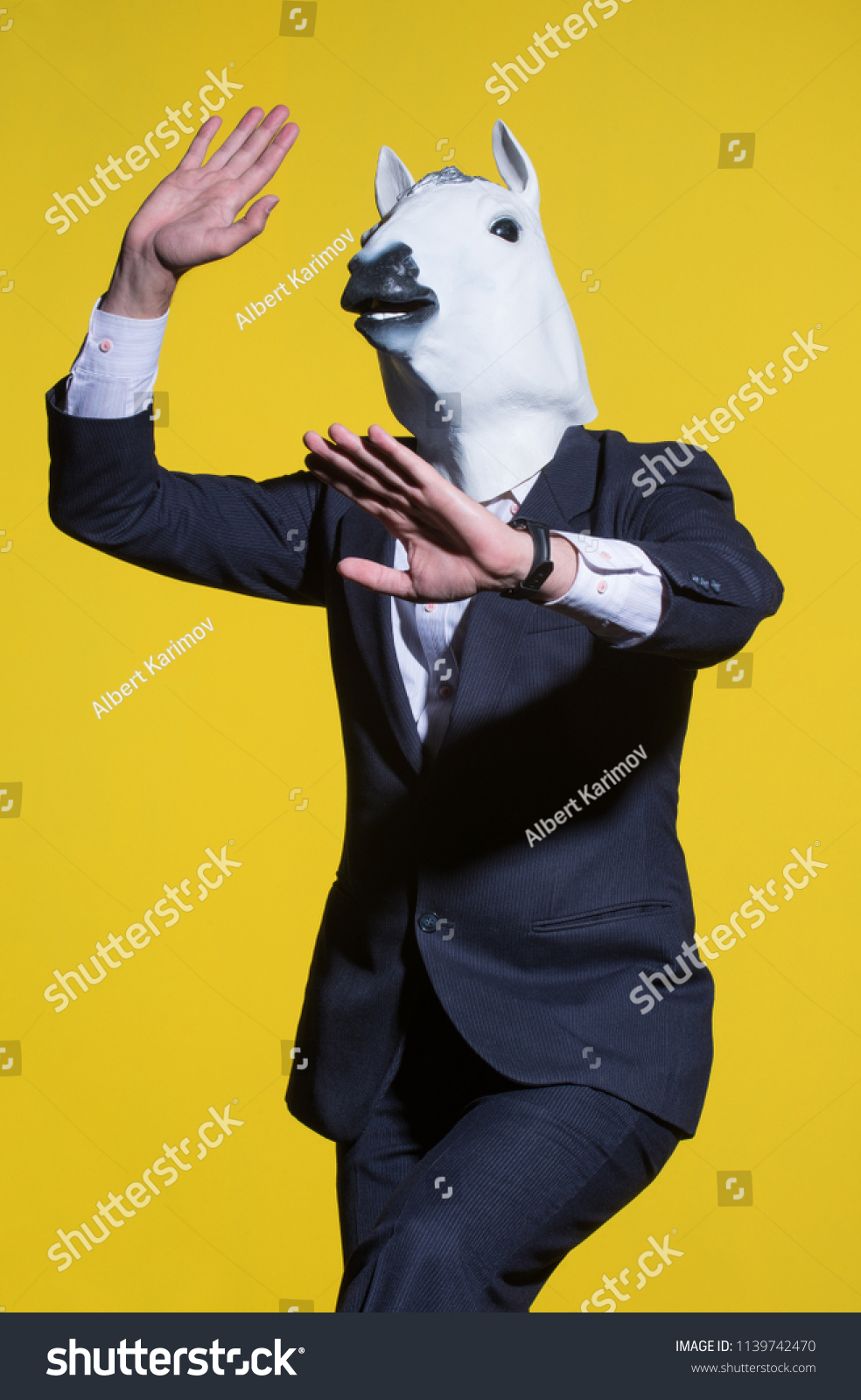 Download Man Suit Horse Mask On Yellow Stock Photo Edit Now 1139742470 PSD Mockup Templates