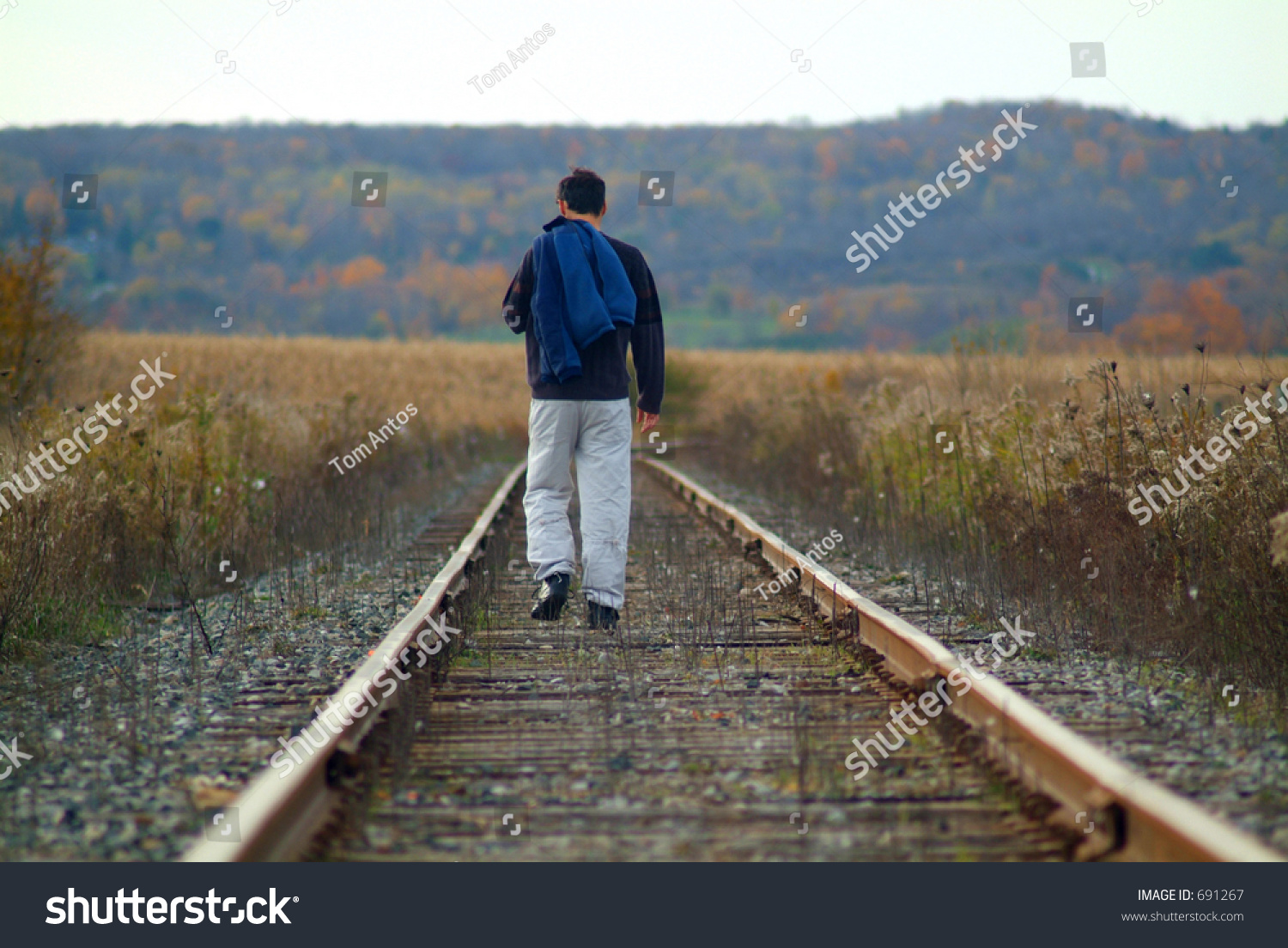 Man Walking Along Train Tracks Stock Photo 691267 - Shutterstock