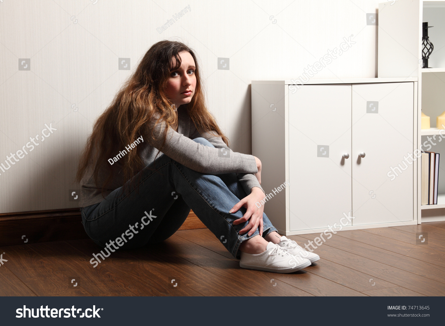 A Nervous And Frightened Looking Teenage Girl Sitting Alone On The ...