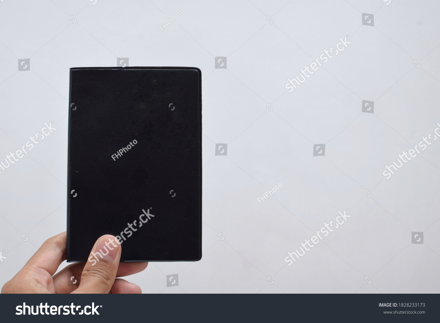 person-holding-black-passport-isolated-white-stock-photo-1828233173