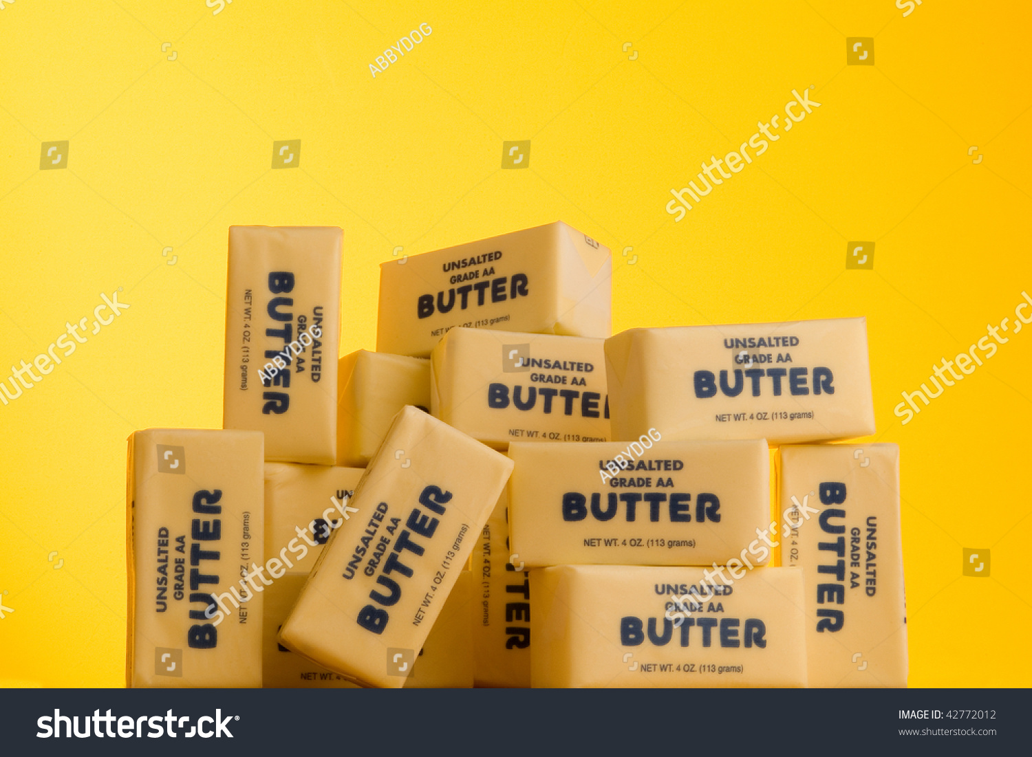 Download Pile Butter Sticks On Yellow Background Stock Photo Edit Now 42772012 PSD Mockup Templates