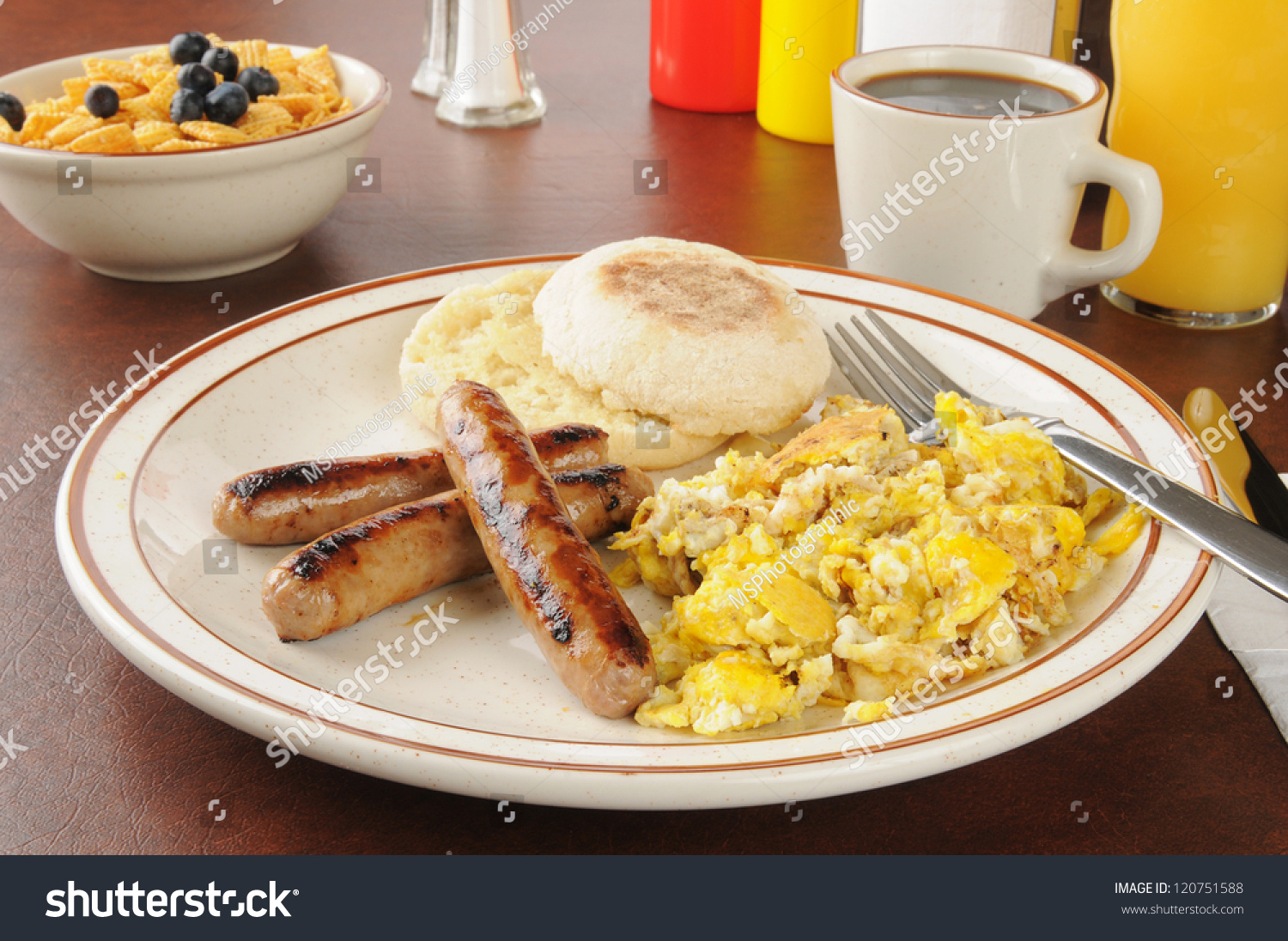 A Plate Of Sausage And Scrambled Eggs With An English Muffin Stock ...