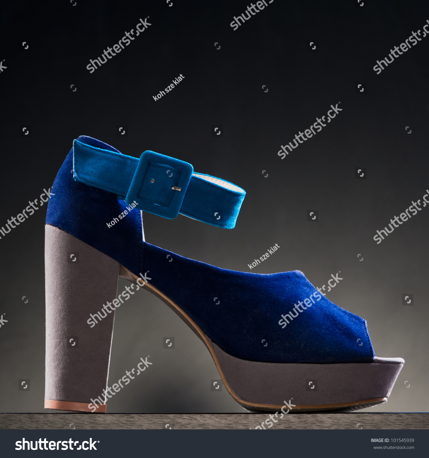 A Product Shot Of High Heel Shoe Against A Dark Coloured Background ...