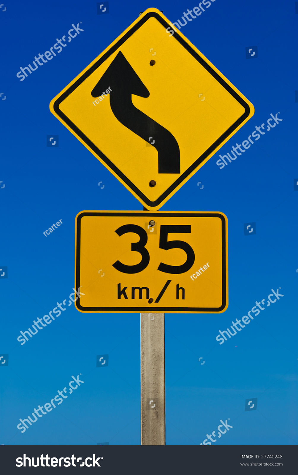 A Road Sign Indicating A Bend In The Road With A Recommended Speed Of ...