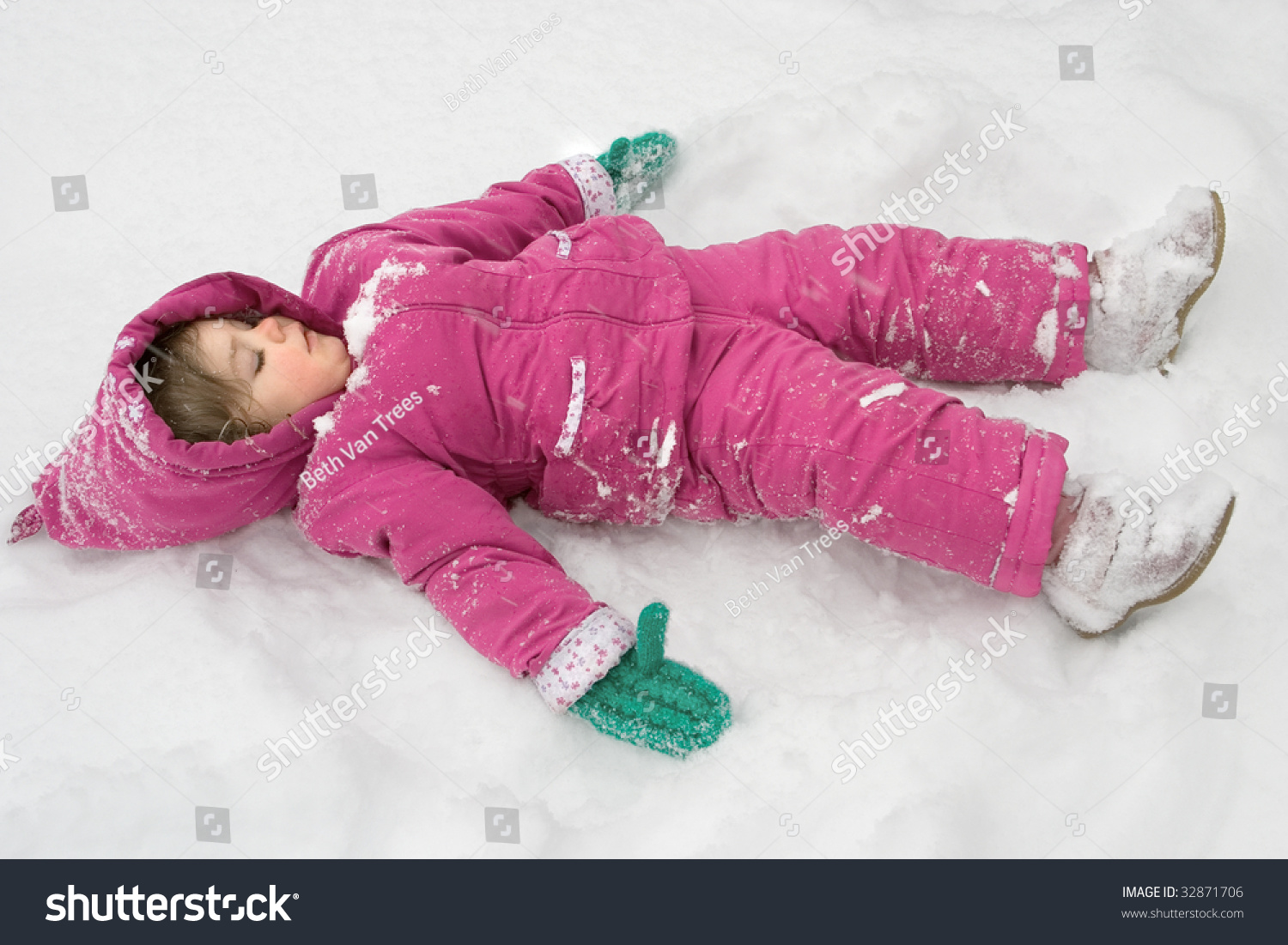 A Serious Little Girl Making A Snow Angel Stock Photo 32871706 ...