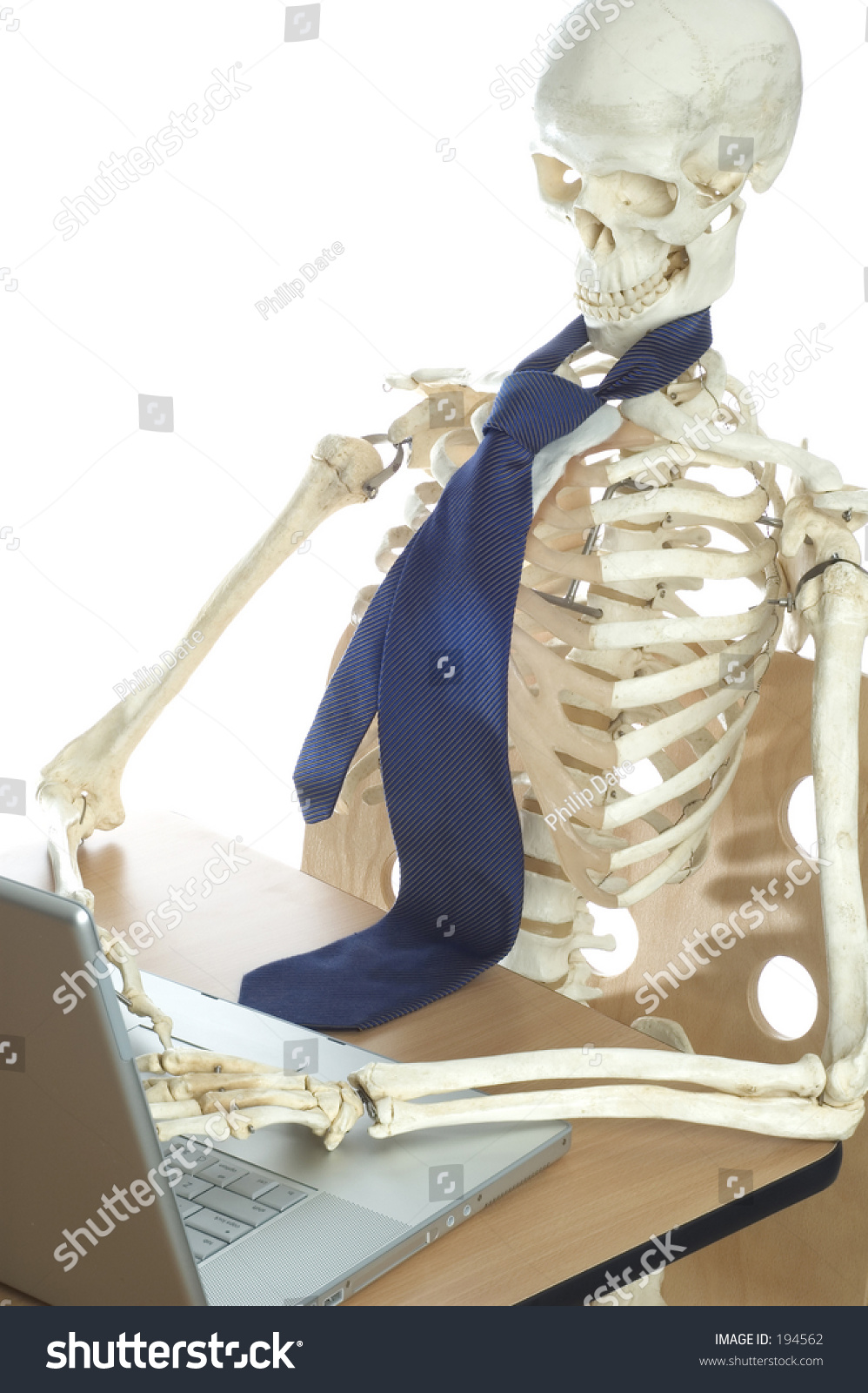 stock-photo-a-skeleton-sits-at-a-desk-typing-on-a-laptop-computer-194562.jpg