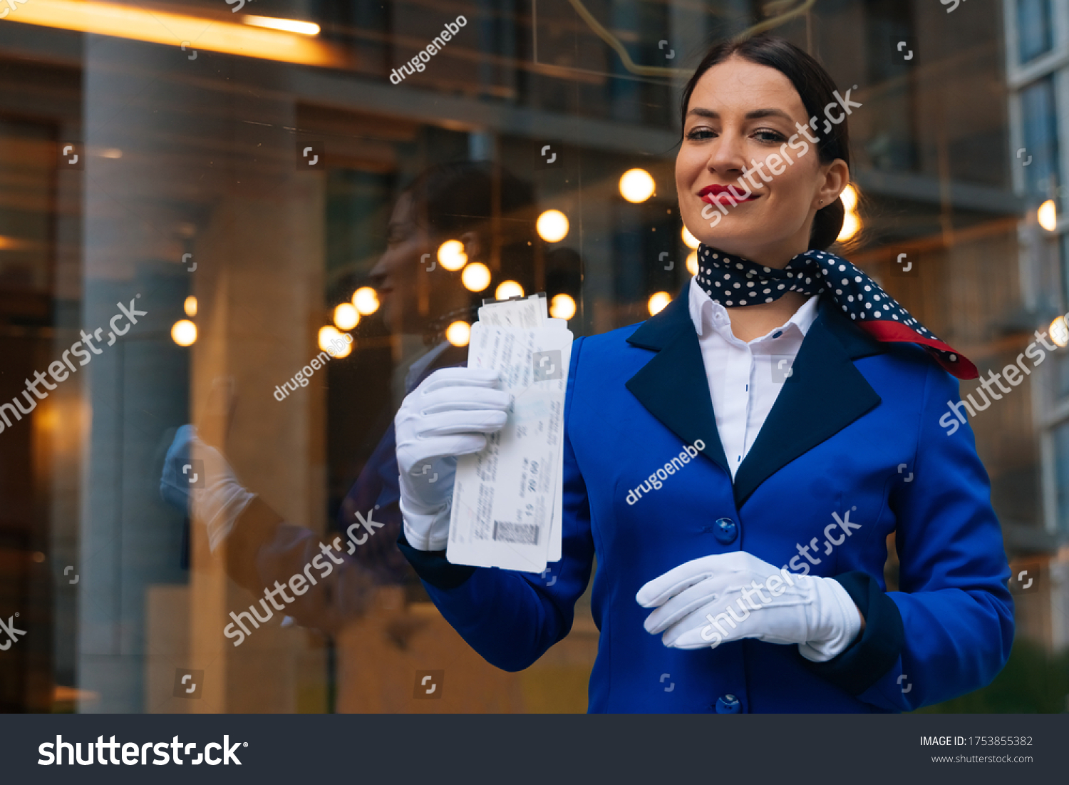 Smiling Flight Attendant Holds Boarding Pass Stock Photo (Edit Now