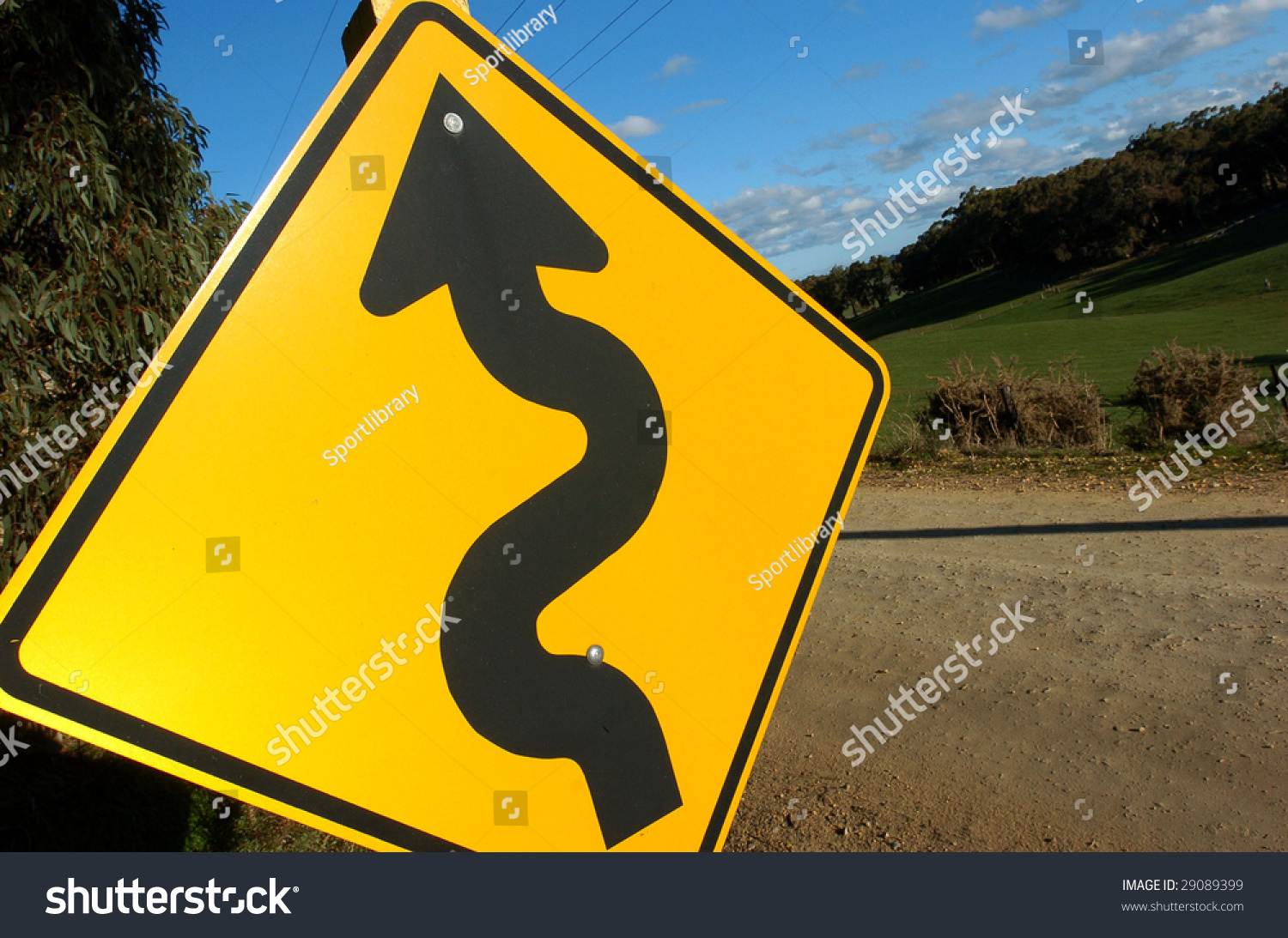 A Windy Road Is Warned By A Big Yellow Sign Showing A Windy Arrow ...