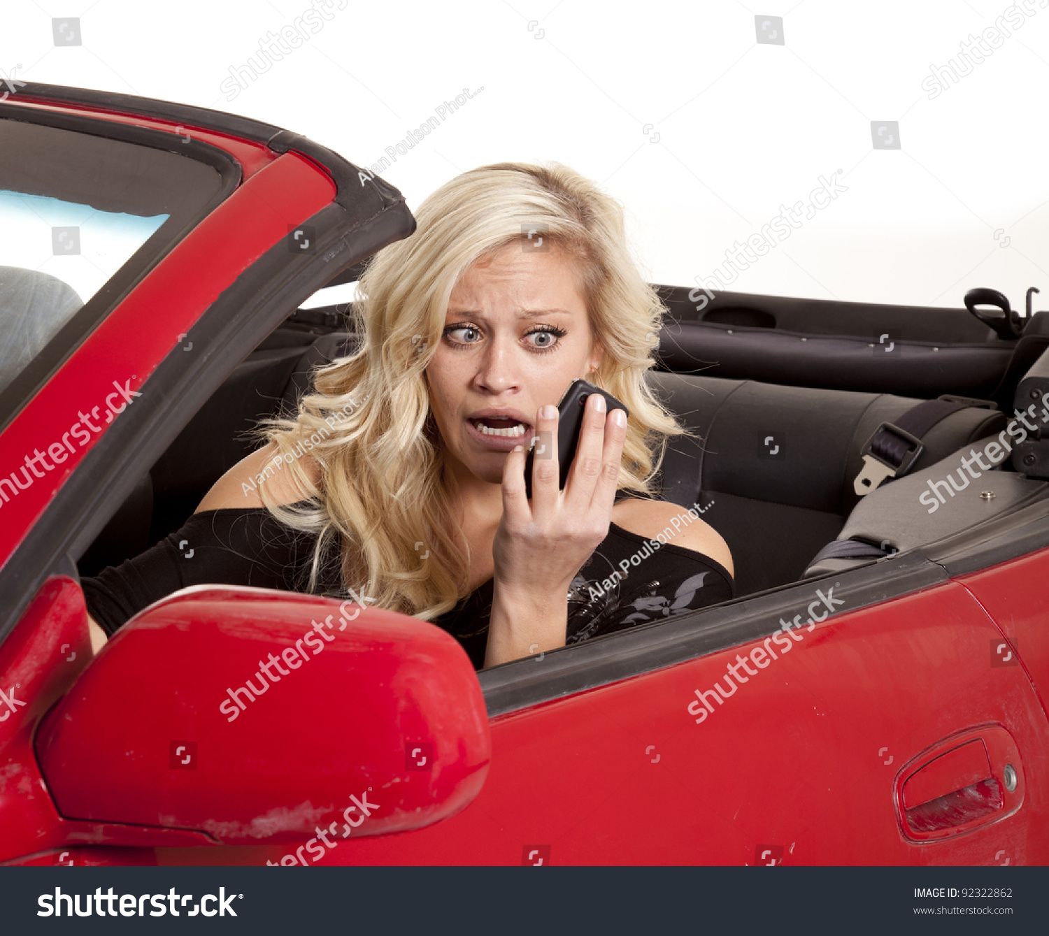 A Woman Looking At Her Cell Phone With A Funny Expression On Her Face ...