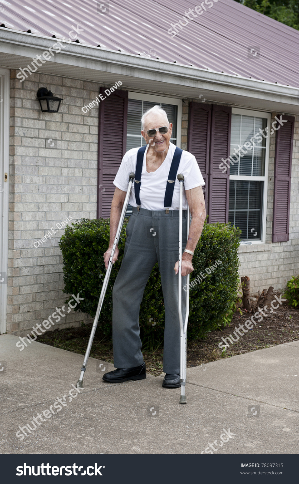 A 93 Year Old Elderly Man With Crutches, Standing Alone Outside His ...