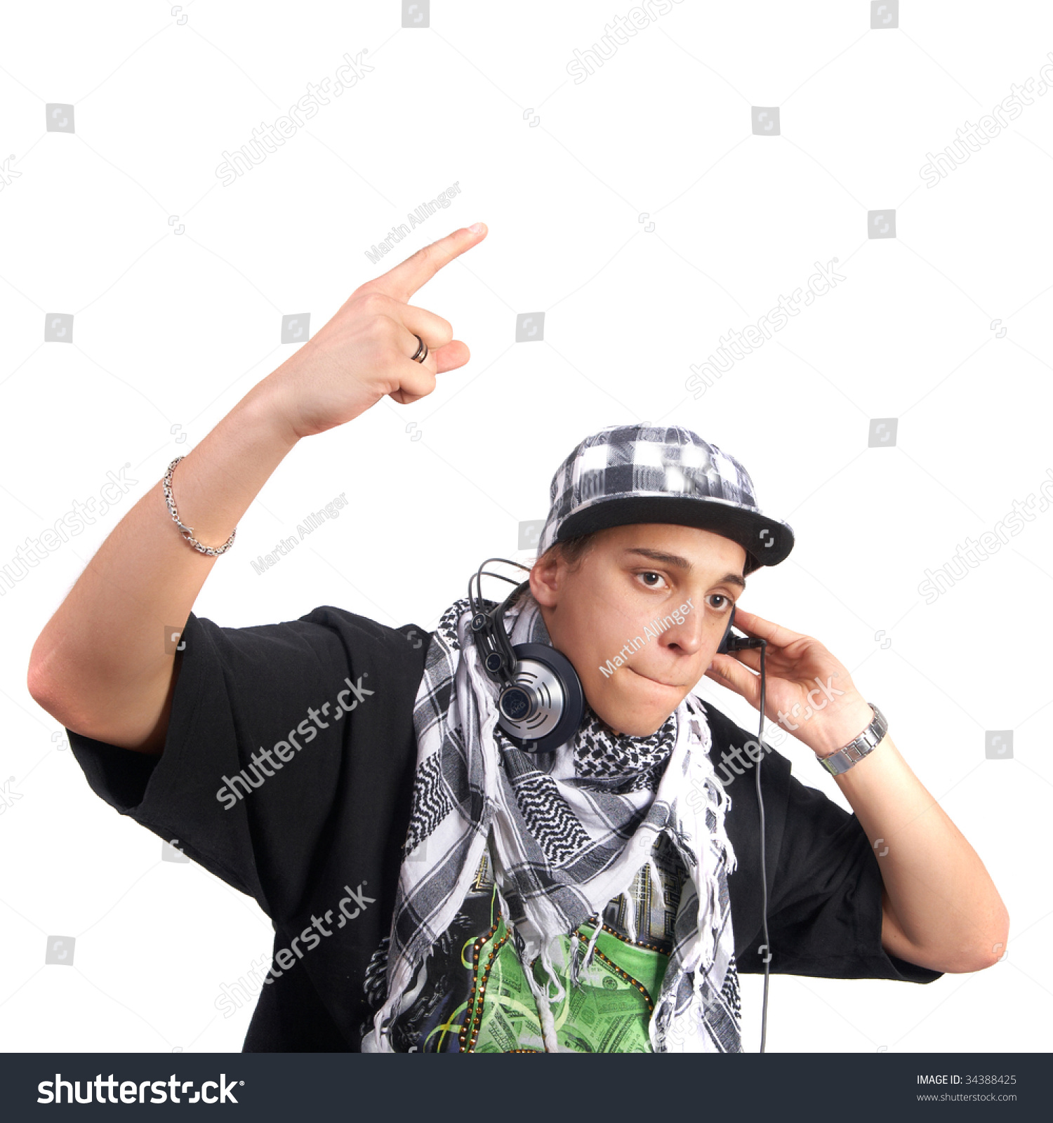 A Young Dj Is Pointing Up. He Is Listening To Music On His Headphones ...