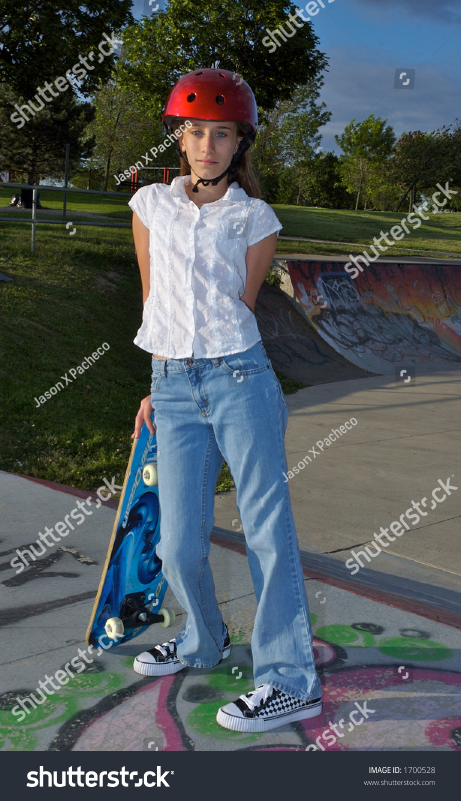 A Young Girl Leaning On Her Skateboard Stock Photo 1700528 : Shutterstock