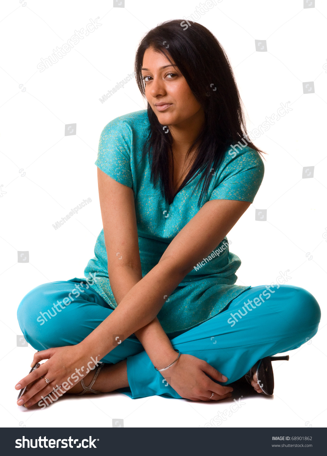 A Young Sian Woman Sitting With Crossed Legs And Arms Isolated On White ...