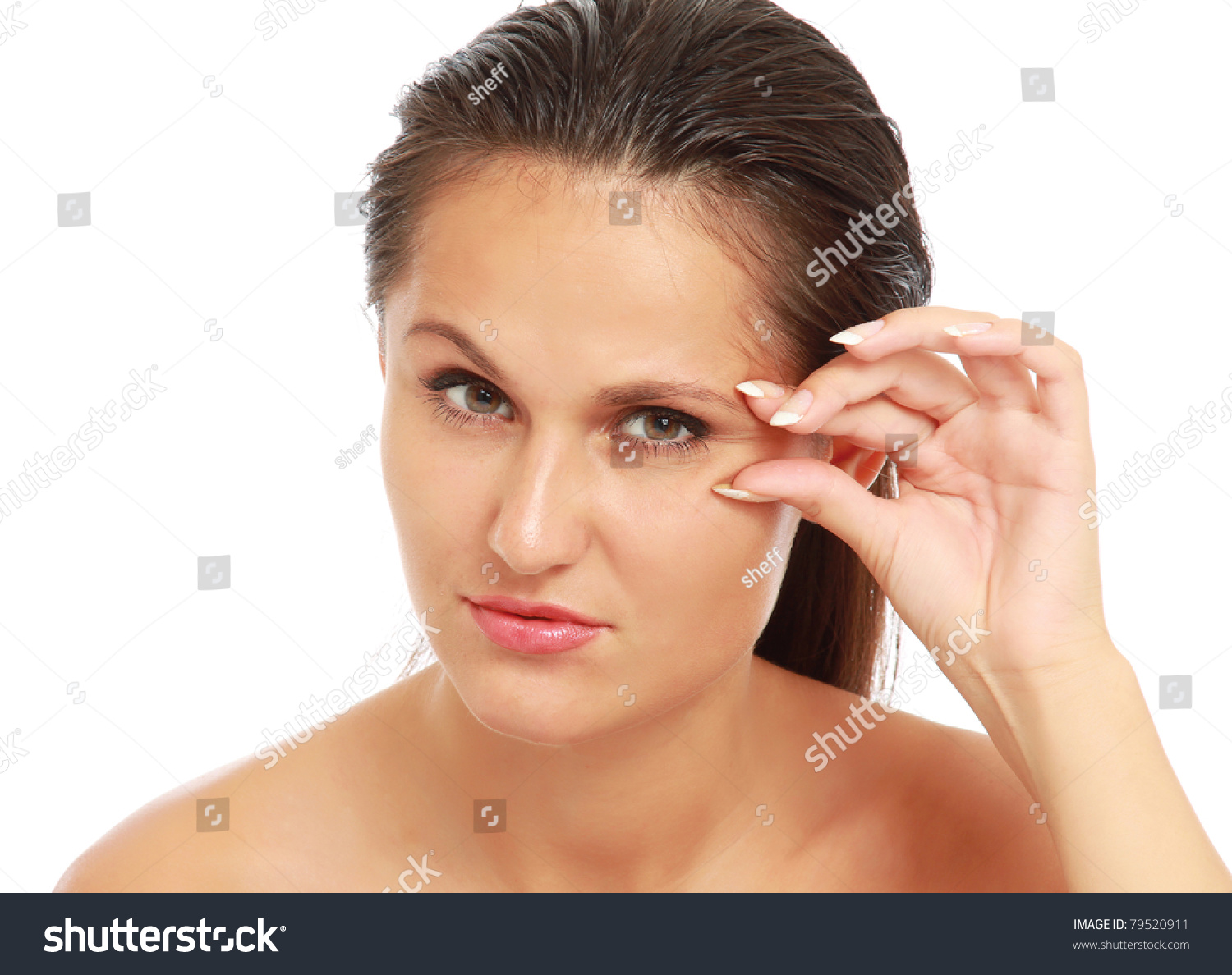 A Young Woman Checking Wrinkles On Her Face, Closeup, Isolated On White ...